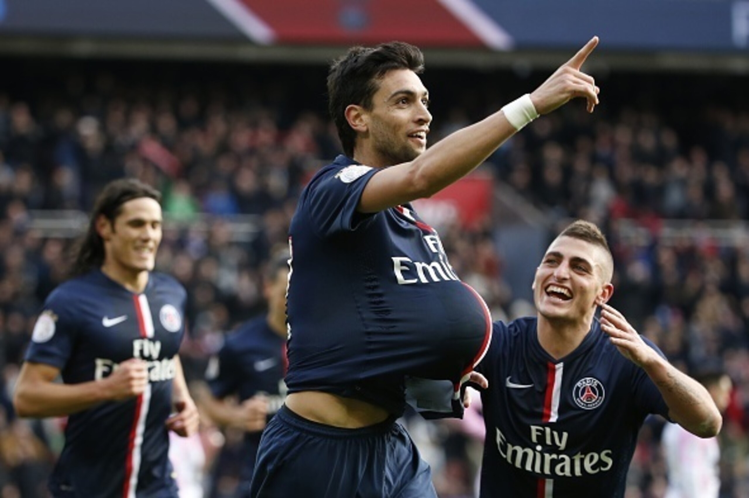 Paris Saint-Germain's Argentinian midfielder Javier Pastore (C) gestures as he celebrates after scoring a goal with Paris Saint-Germain's Italian midfielder Marco Verratti (R) during the French L1 football match between Paris Saint-Germain (PSG) and Evian
