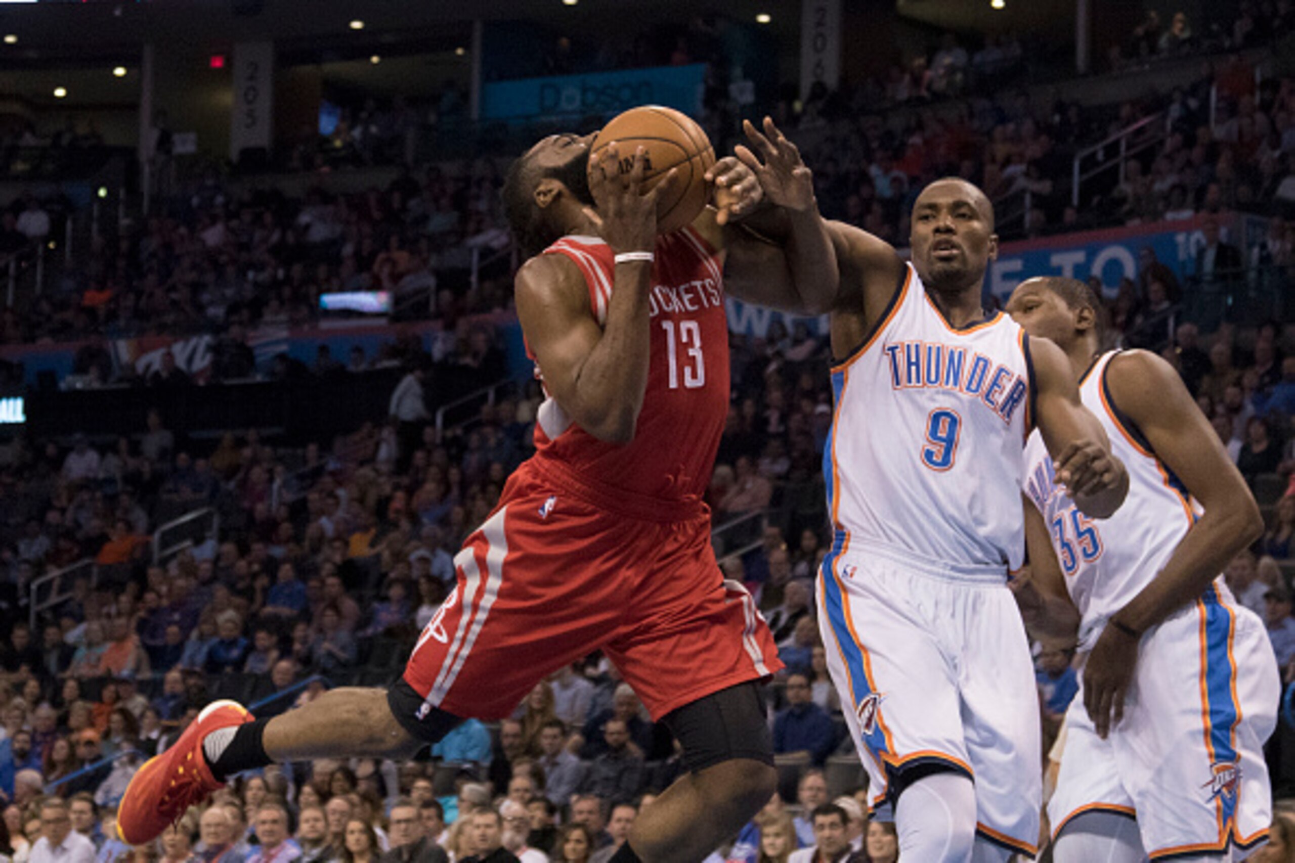 OKLAHOMA CITY, OK - JANUARY 29: Serge Ibaka #9 of the Oklahoma City Thunder blocks James Harden #13 of the Houston Rockets during a NBA game at the Chesapeake Energy Arena on January 29, 2016 in Oklahoma City, Oklahoma. NOTE TO USER: User expressly acknow