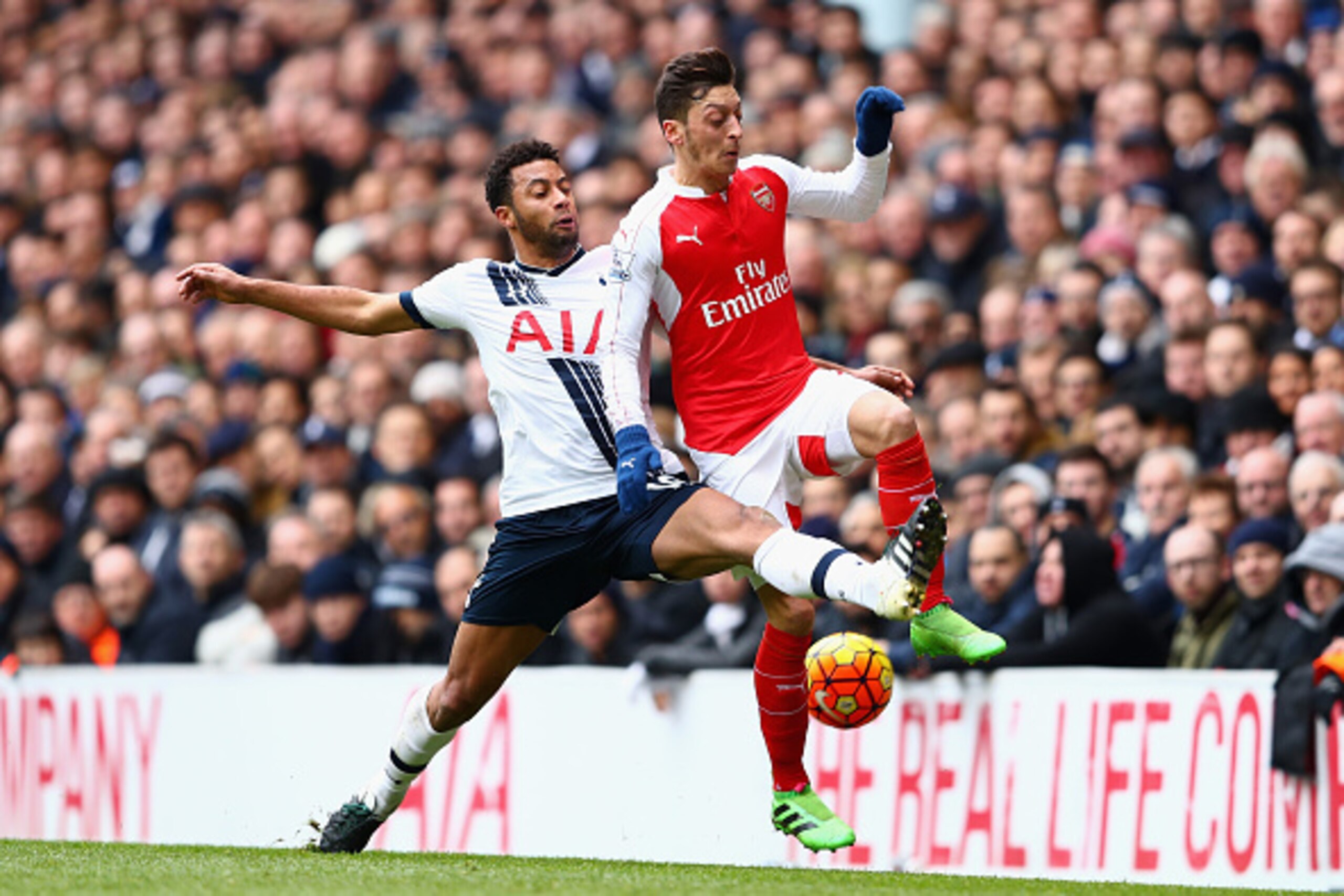 LONDON, ENGLAND - MARCH 05: Mesut Ozil of Arsenal and Mousa Dembele of Tottenham Hotspur  compete for the ball during the Barclays Premier League match between Tottenham Hotspur and Arsenal at White Hart Lane on March 5, 2016 in London, England.  (Photo b