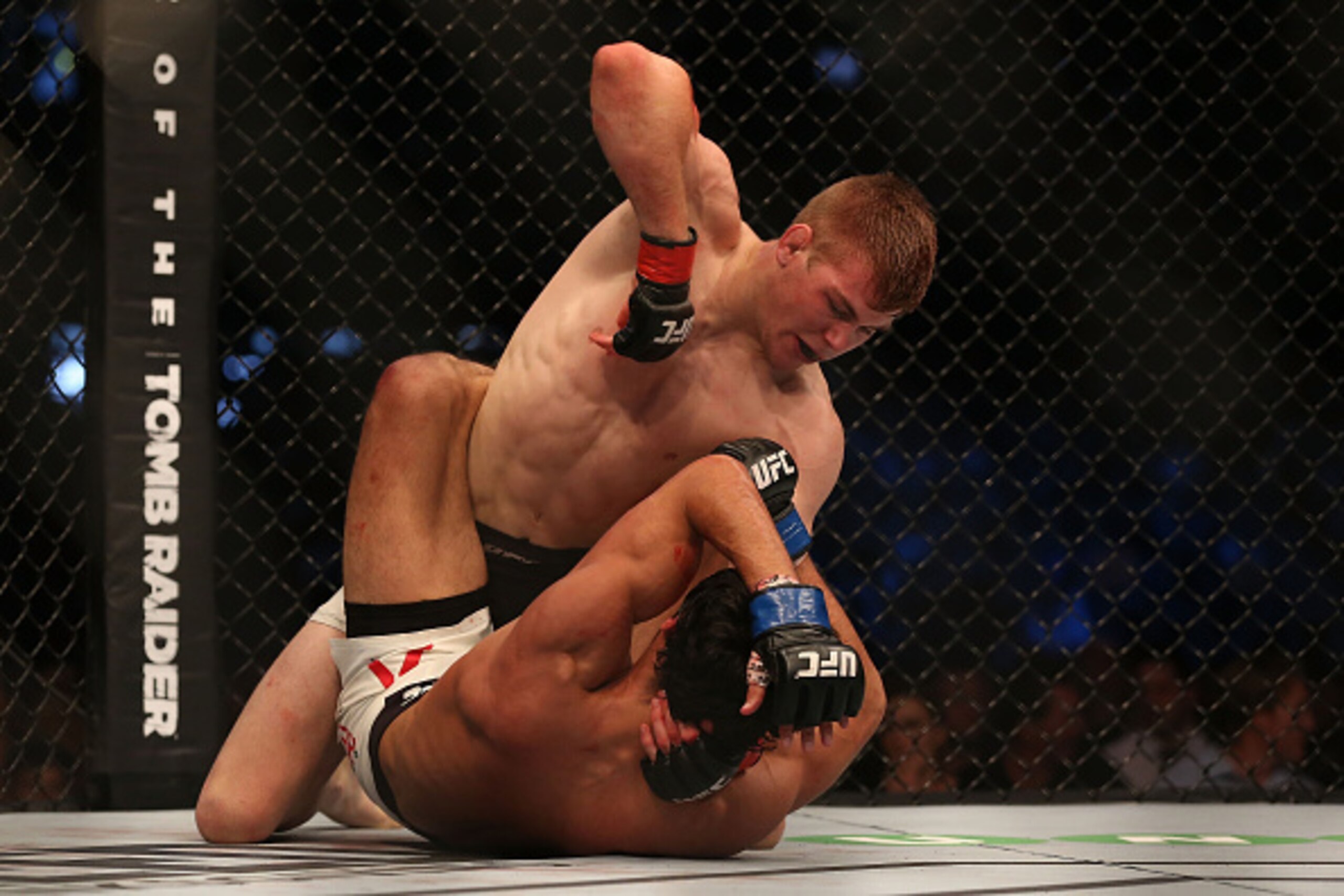 MELBOURNE, AUSTRALIA - NOVEMBER 15:  Jake Matthews of Australia pins down Akbar Arreola of Mexico in their lightweight bout during the UFC 193 event at Etihad Stadium on November 15, 2015 in Melbourne, Australia.  (Photo by Quinn Rooney/Getty Images)