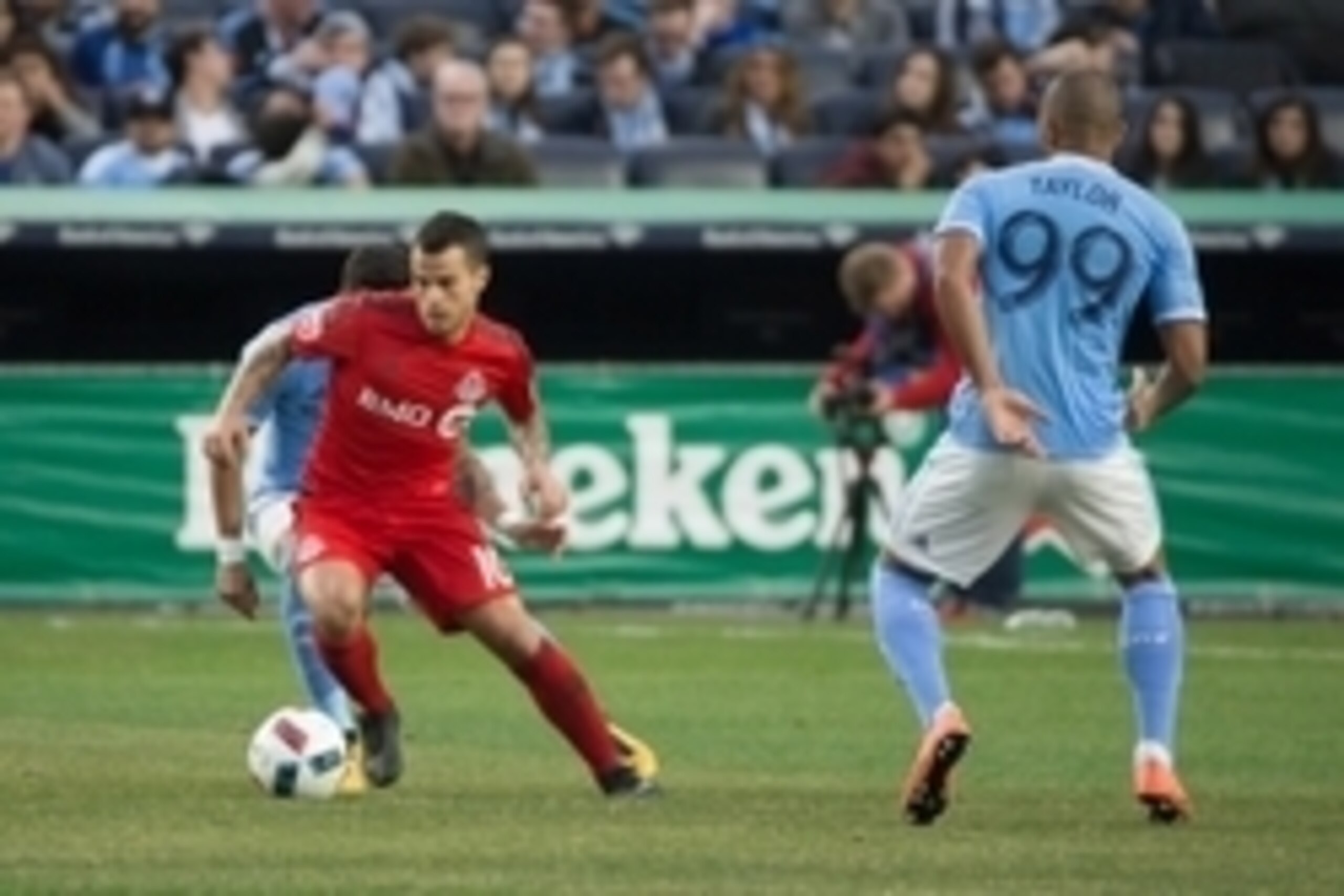 Mar 13, 2016; New York, NY, USA;  Toronto FC forward Sebastian Giovinco (10) advances the ball in front of New York City FC forward Tony Taylor (99) at Yankee Stadium. Toronto tied New York City, 2-2.  Mandatory Credit: Vincent Carchietta-USA TODAY Sports
