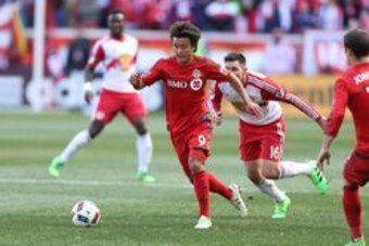 Mar 6, 2016; Harrison, NJ, USA; Toronto FC midfielder Tsubasa Endoh (9) dribbles up field in front of New York Red Bulls midfielder Sacha Kljestan (16) during the first half at Red Bull Arena. Mandatory Credit: Vincent Carchietta-USA TODAY Sports