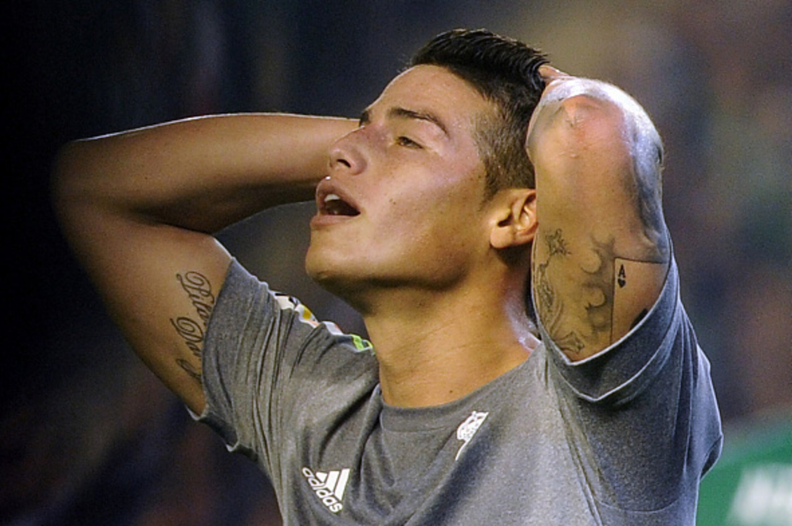 Real Madrid's Colombian midfielder James Rodriguez gestures during the Spanish league football match Real Betis Balompie vs Real Madrid CF at the Benito Villamarin stadium in Sevilla on January 24, 2016.The match ended in a draw 1-1.  AFP PHOTO / CRISTINA