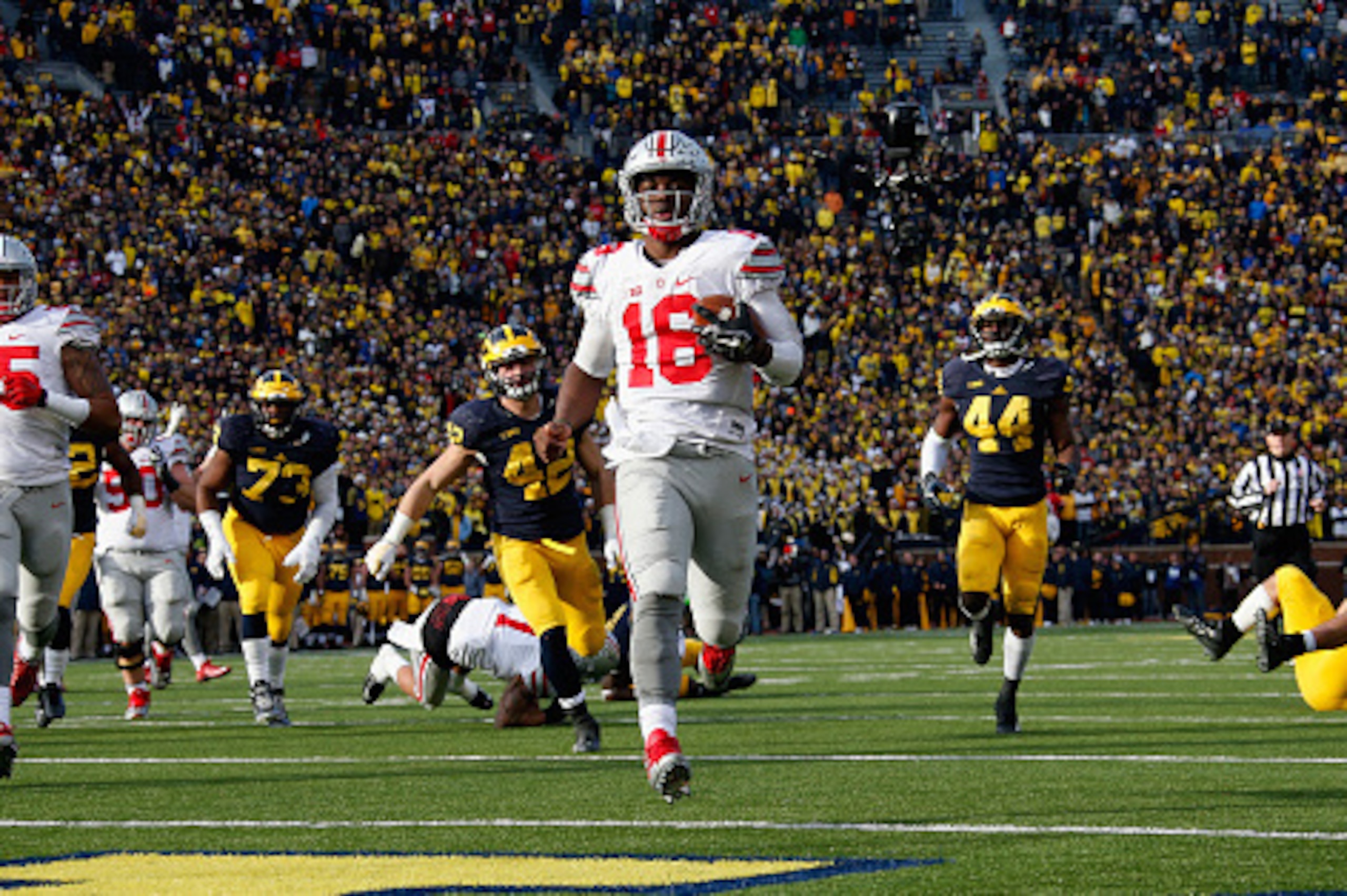 ANN ARBOR, MI - NOVEMBER 28: Quarterback J.T. Barrett #16 of the Ohio State Buckeyes rushes for a fourth quarter touchdown against the Michigan Wolverines at Michigan Stadium on November 28, 2015 in Ann Arbor, Michigan.  (Photo by Gregory Shamus/Getty Ima