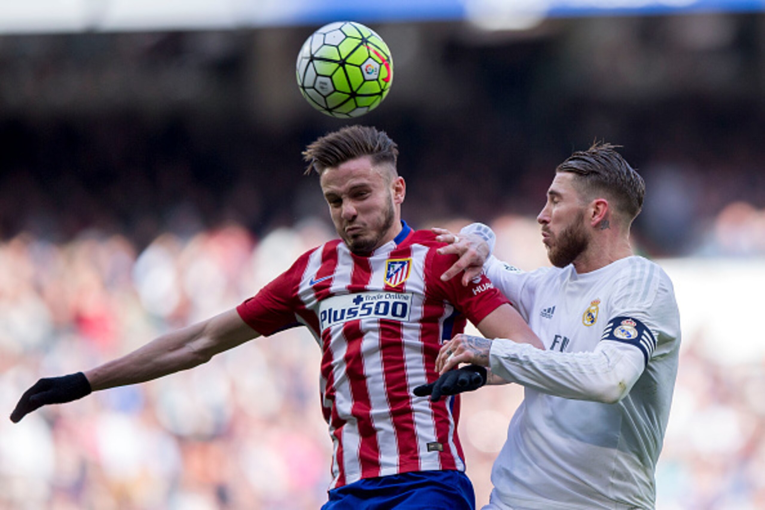 MADRID, SPAIN - FEBRUARY 27: Saul Niguez of Atletico de Madrid wins the header before Sergio Ramos of Real Madrid CF during the La Liga match between Real Madrid CF and Club Atletico de Madrid at Estadio Santiago Bernabeu on February 27, 2016 in Madrid, S MADRID, SPAIN - FEBRUARY 27: Saul Niguez of Atletico de Madrid wins the header before Sergio Ramos of Real Madrid CF during the La Liga match between Real Madrid CF and Club Atletico de Madrid at Estadio Santiago Bernabeu on February 27, 2016 in Madrid, S