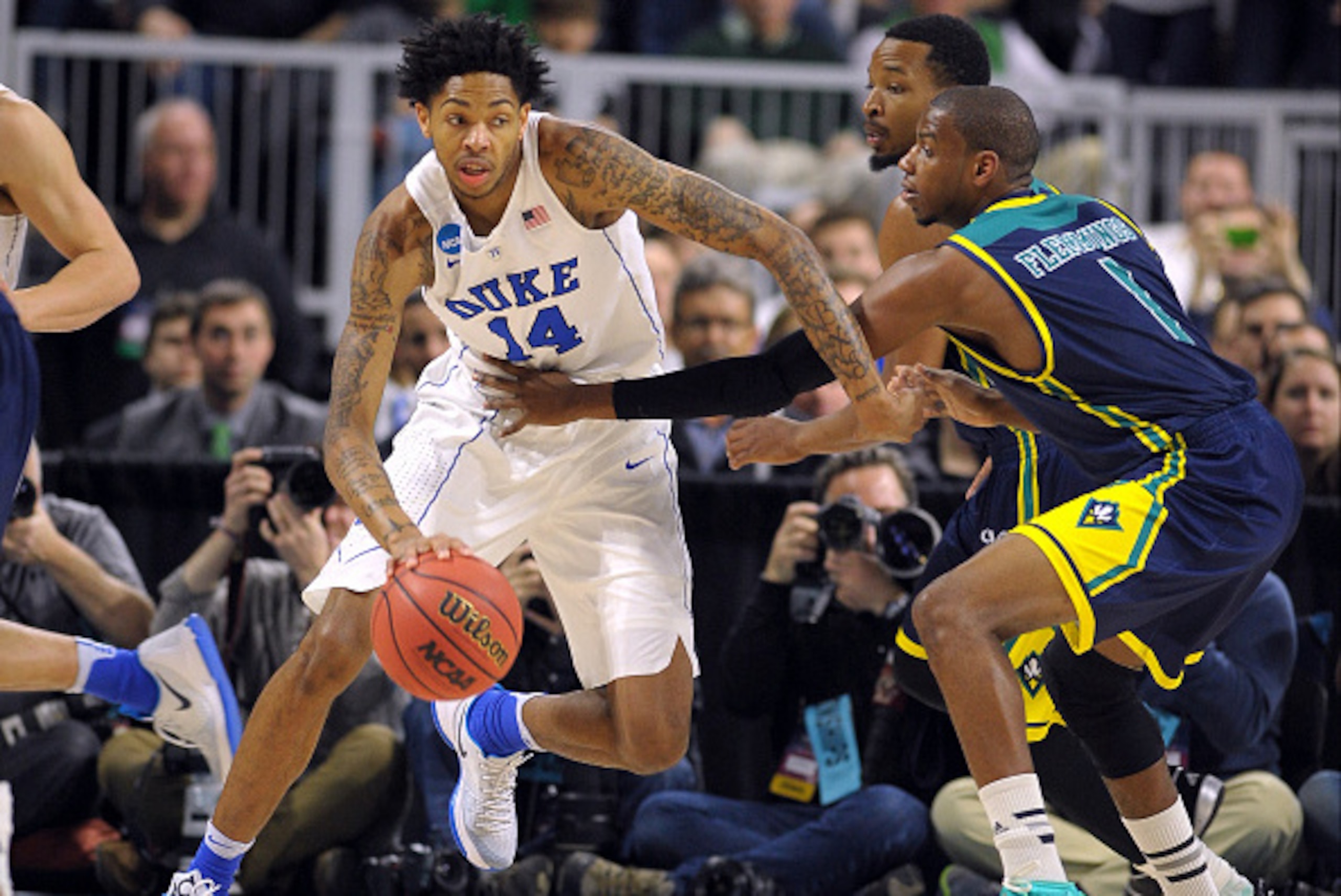 PROVIDENCE, RI - MARCH 17: Brandon Ingram #14 of the Duke Blue Devils moves the ball against Chris Flemmings #1 of the North Carolina-Wilmington Seahawks during the first round of the 2016 NCAA Men's Basketball Tournament at Dunkin' Donuts Center on March