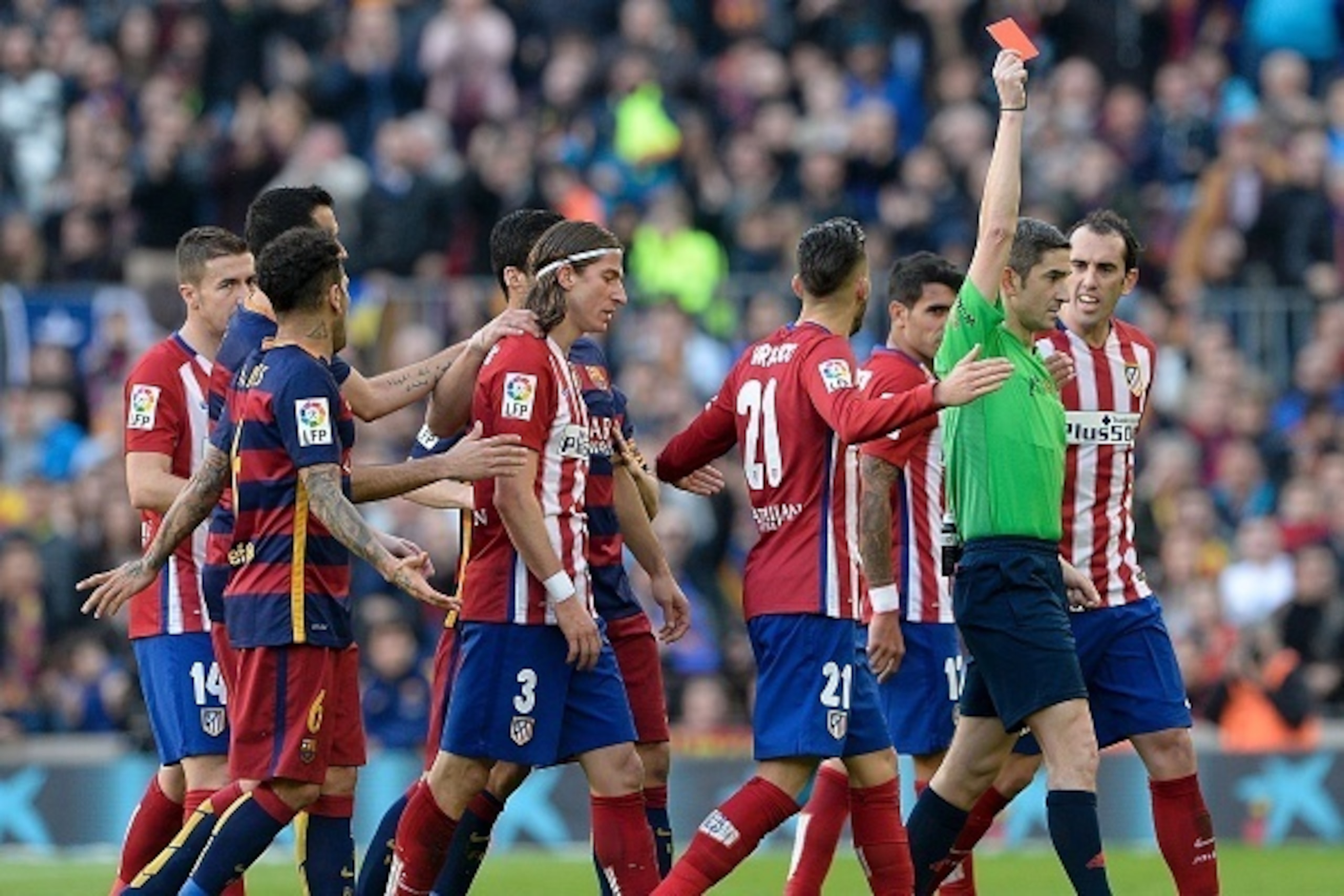 Atletico Madrid's Brazilian defender Filipe Luis (2ndL) looks dejected after he was shown a red card during the Spanish league football match FC Barcelona vs Club Atletico de Madrid at the Camp Nou stadium in Barcelona on January 30, 2016. AFP PHOTO/ JOSE