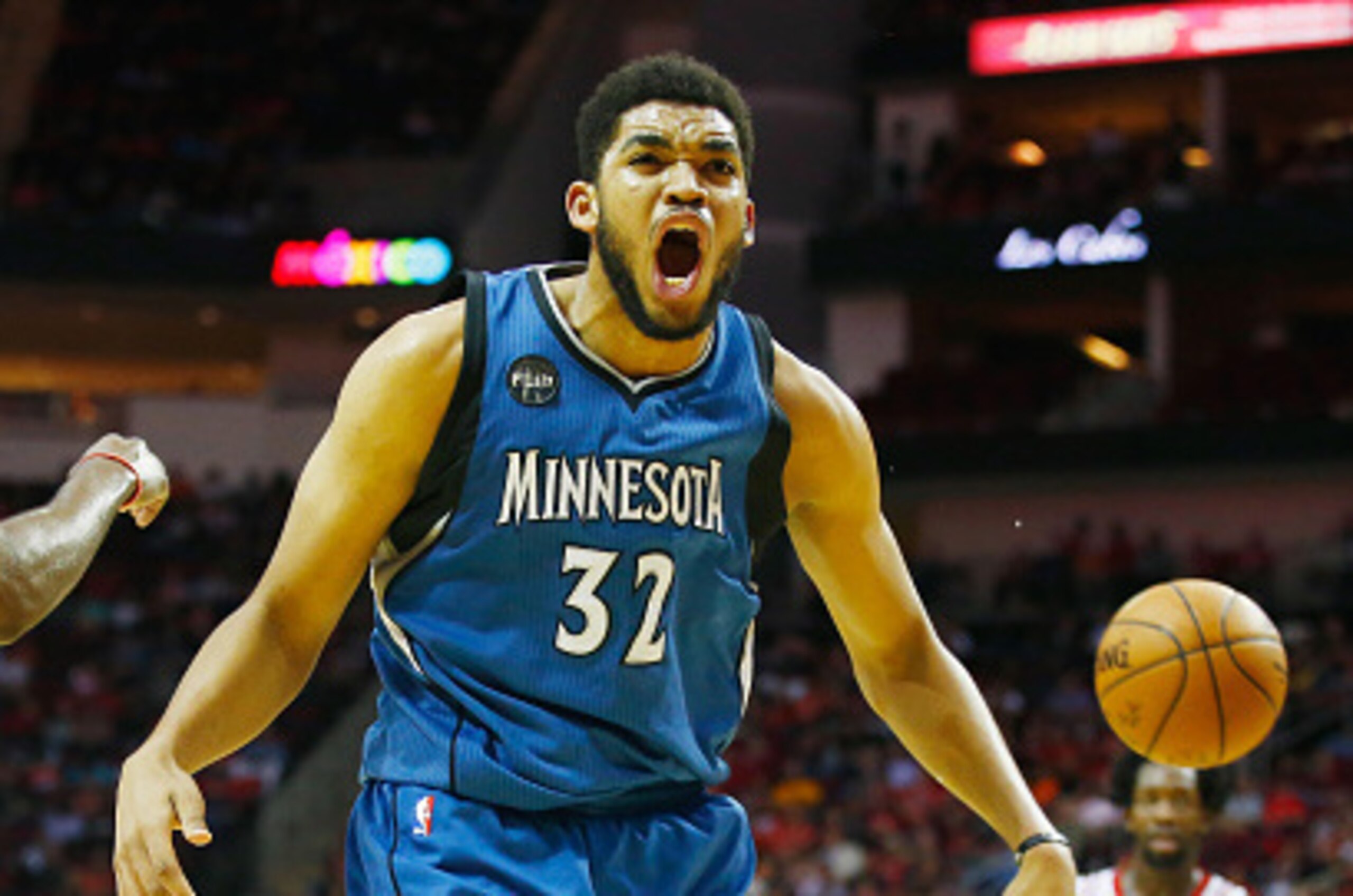 HOUSTON, TX - MARCH 18:  Karl-Anthony Towns #32 of the Minnesota Timberwolves reacts to a call in front of James Harden #13 of the Houston Rockets on the court during their game at the Toyota Center on March 18, 2016 in Houston, Texas.  NOTE TO USER: User