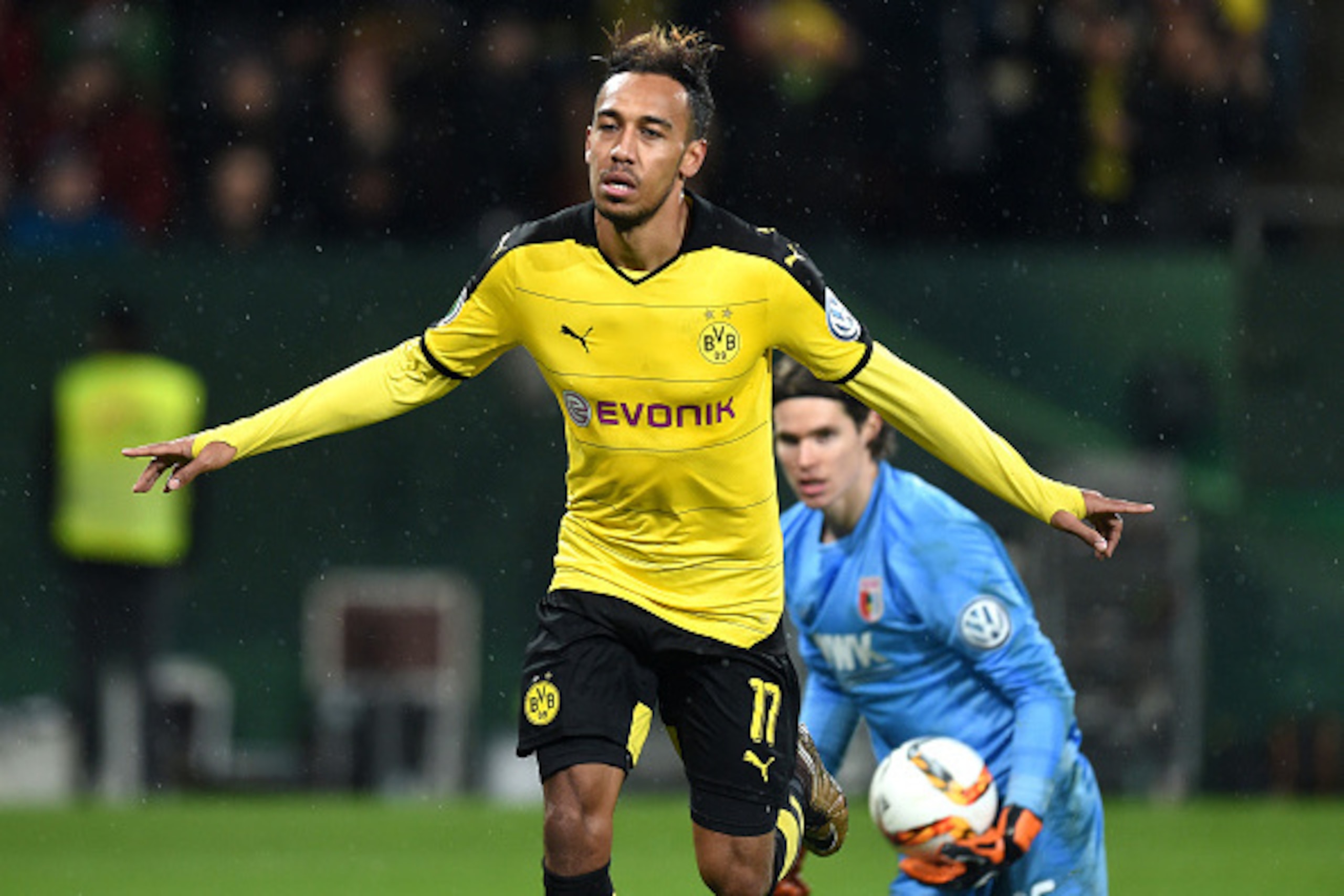 Dortmund's Gabonese striker Pierre-Emerick Aubameyang (L) celebrates after his goal beside Augsburg's Swiss goalkeeper Marwin Hitz during the German Cup DFB Pokal third round match between Borussia Dortmund and FC Augsburg in Augsburg on December 16, 2015