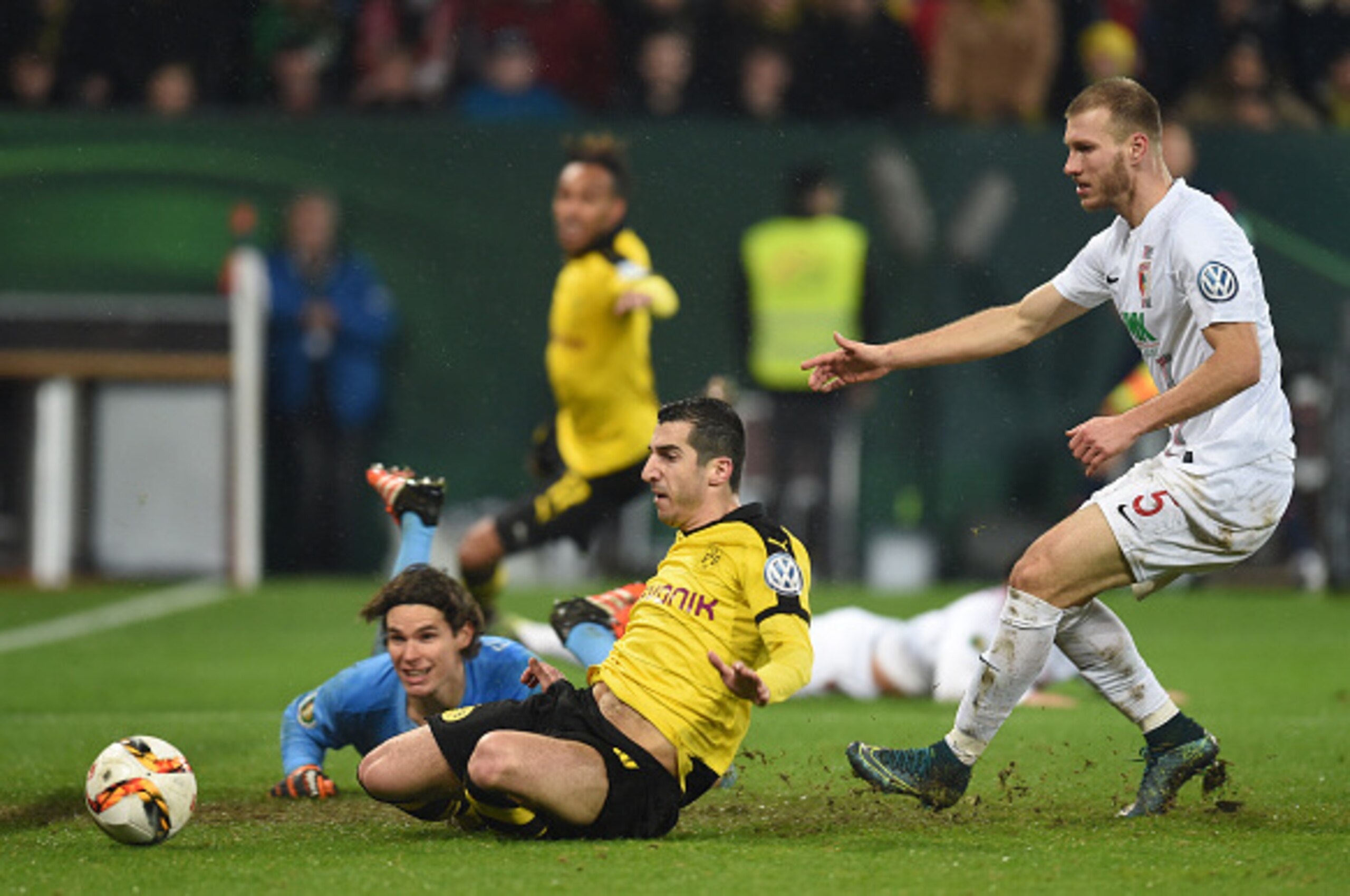 (L-R) Augsburg's Swiss goalkeeper Marwin Hitz, Dortmund's Armenian midfielder Henrikh Mkhitaryan and Augsburg's Estonian defender Ragnar Klavan vie for the ballvie during the German Cup DFB Pokal third round match between Borussia Dortmund and FC Augsburg