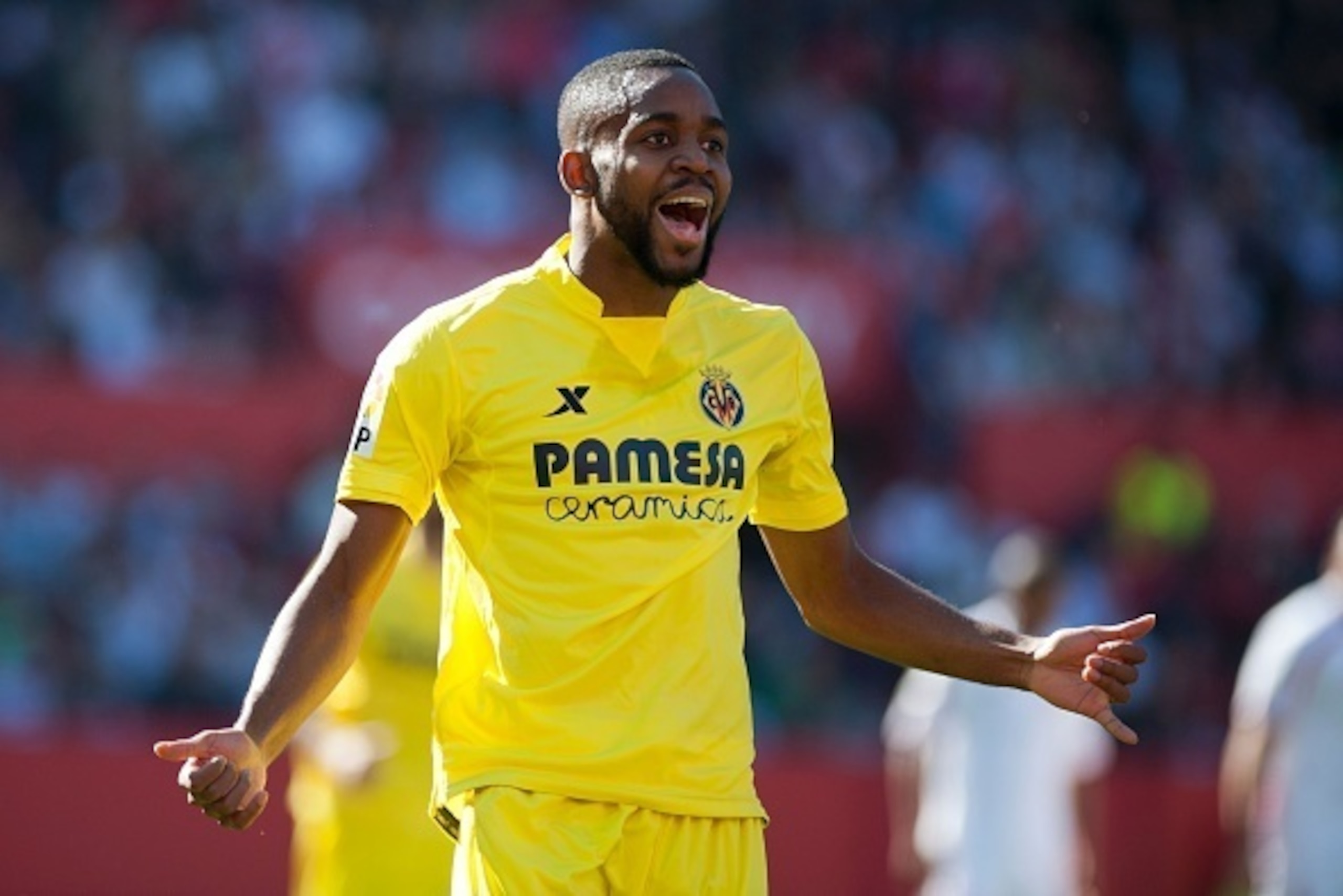 Villarreal's French forward Cedric Bakambu celebrates after scoring during the Spanish league football match Sevilla FC vs Villarreal CF at the Ramon Sanchez Pizjuan stadium in Sevilla on March 13, 2016. / AFP / JORGE GUERRERO        (Photo credit should 