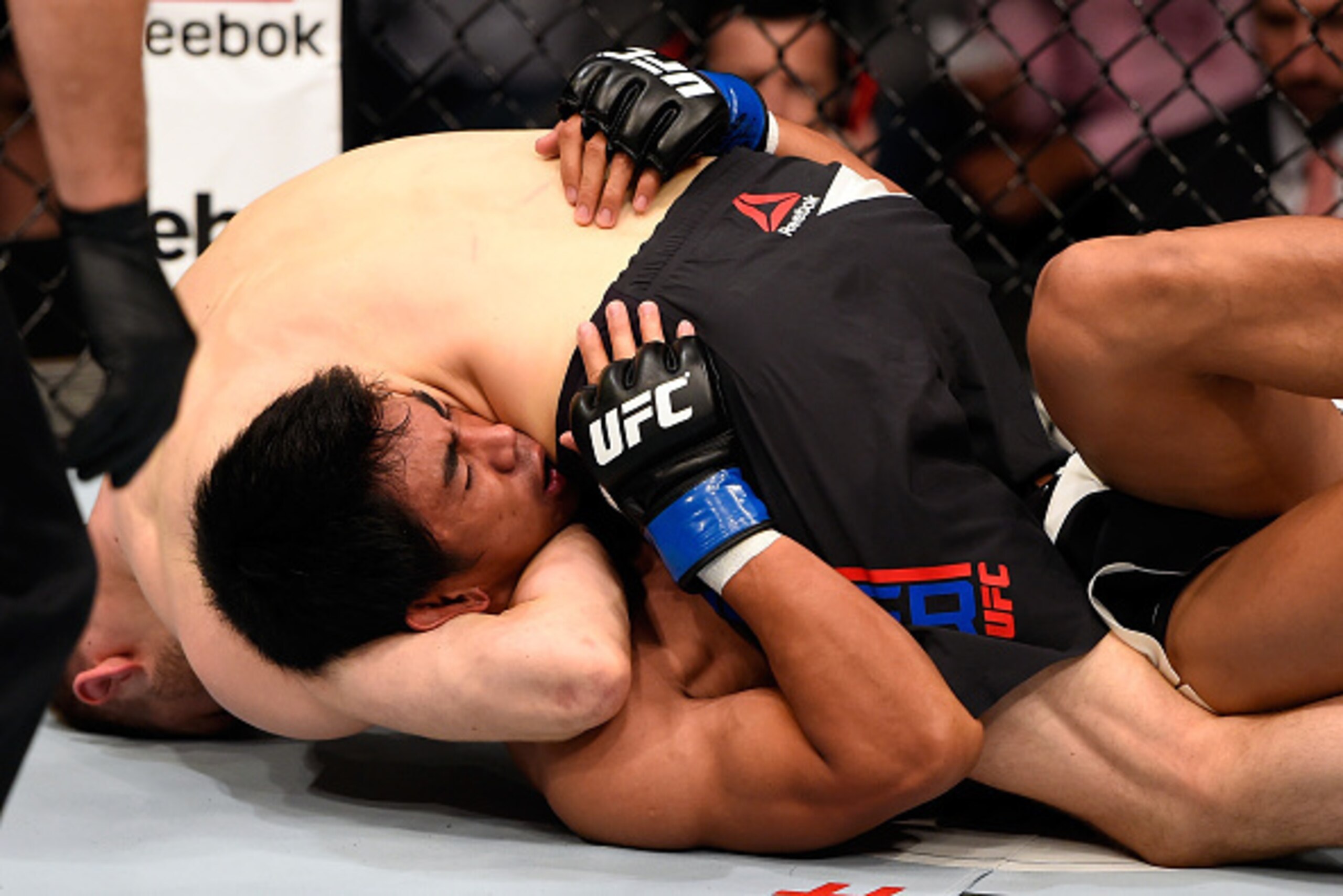 BRISBANE, AUSTRALIA - MARCH 20:  Dan Hooker (top) of New Zealand submits Mark Eddiva of the Philippines by guillotine choke in their featherweight bout during the UFC Fight Night event at the Brisbane Entertainment Centre on March 20, 2016 in Brisbane, Au