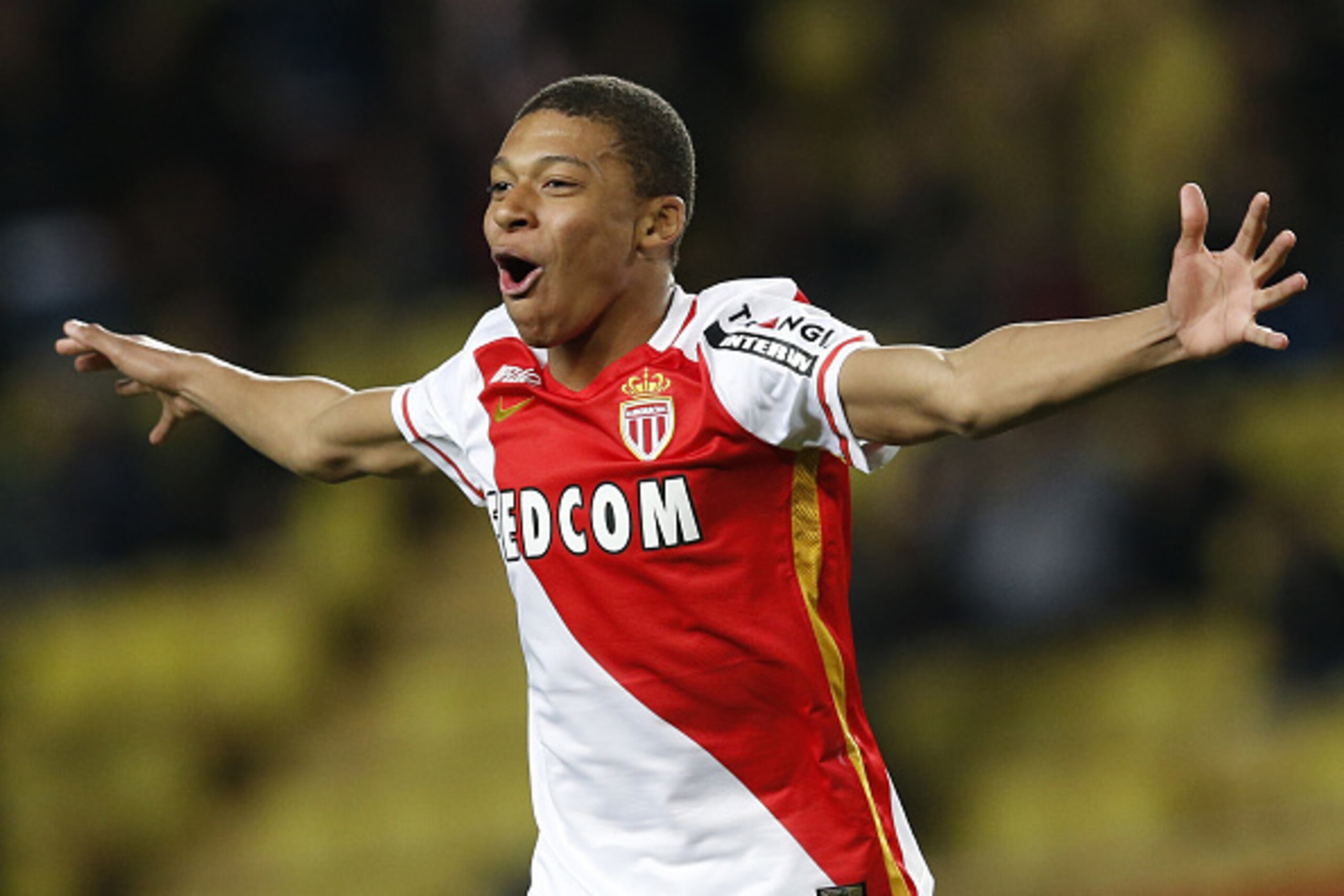 Monaco's French forward Kylian Mbappe Lottin celebrates after scoring a goal during the French L1 football match Monaco (ASM) vs Troyes (ESTAC) on February 20, 2016 at the 'Louis II Stadium' in Monaco.  AFP PHOTO / VALERY HACHE / AFP / VALERY HACHE       