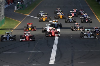 MELBOURNE, AUSTRALIA - MARCH 20:  Sebastian Vettel of Germany and Ferrari leads Nico Rosberg of Germany and Mercedes GP, Kimi Raikkonen of Finland and Ferrari and Lewis Hamilton of Great Britain and Mercedes GP into the first corner during the Australian 