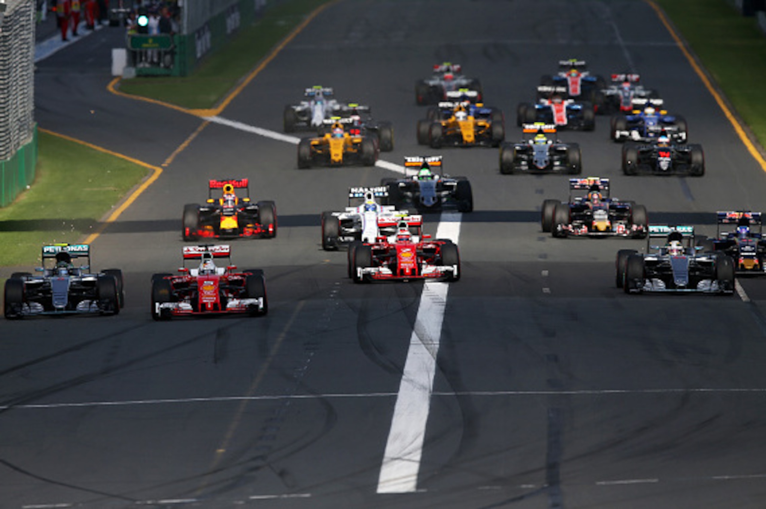 MELBOURNE, AUSTRALIA - MARCH 20:  Sebastian Vettel of Germany and Ferrari leads Nico Rosberg of Germany and Mercedes GP, Kimi Raikkonen of Finland and Ferrari and Lewis Hamilton of Great Britain and Mercedes GP into the first corner during the Australian 
