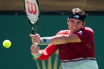 Milos Raonic of Canada returns the ball to David Goffin of Belgium in the men's semifinals March 19, 2016, at the BNP Paribas Open at the Indian Wells Tennis Garden in Indian Wells, California.  Raonic defeated Goffin 3-6, 6-3, 3-6. / AFP / ROBYN BECK    