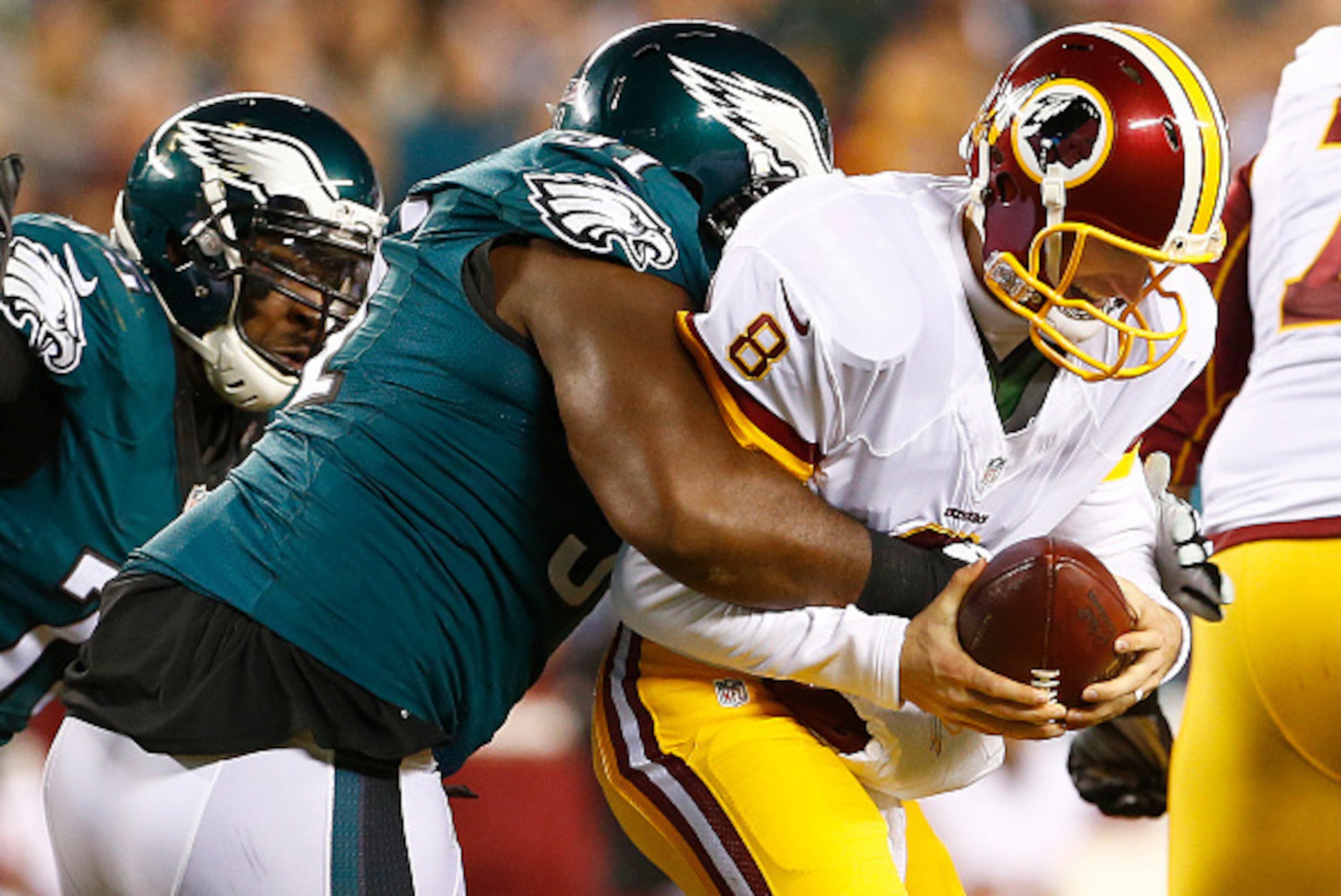 PHILADELPHIA, PA - DECEMBER 26: Quarterback Kirk Cousins #8 of the Washington Redskins is sacked by Fletcher Cox #91 of the Philadelphia Eagles in the second quarter of a football game at Lincoln Financial Field on December 26, 2015 in Philadelphia, Penns
