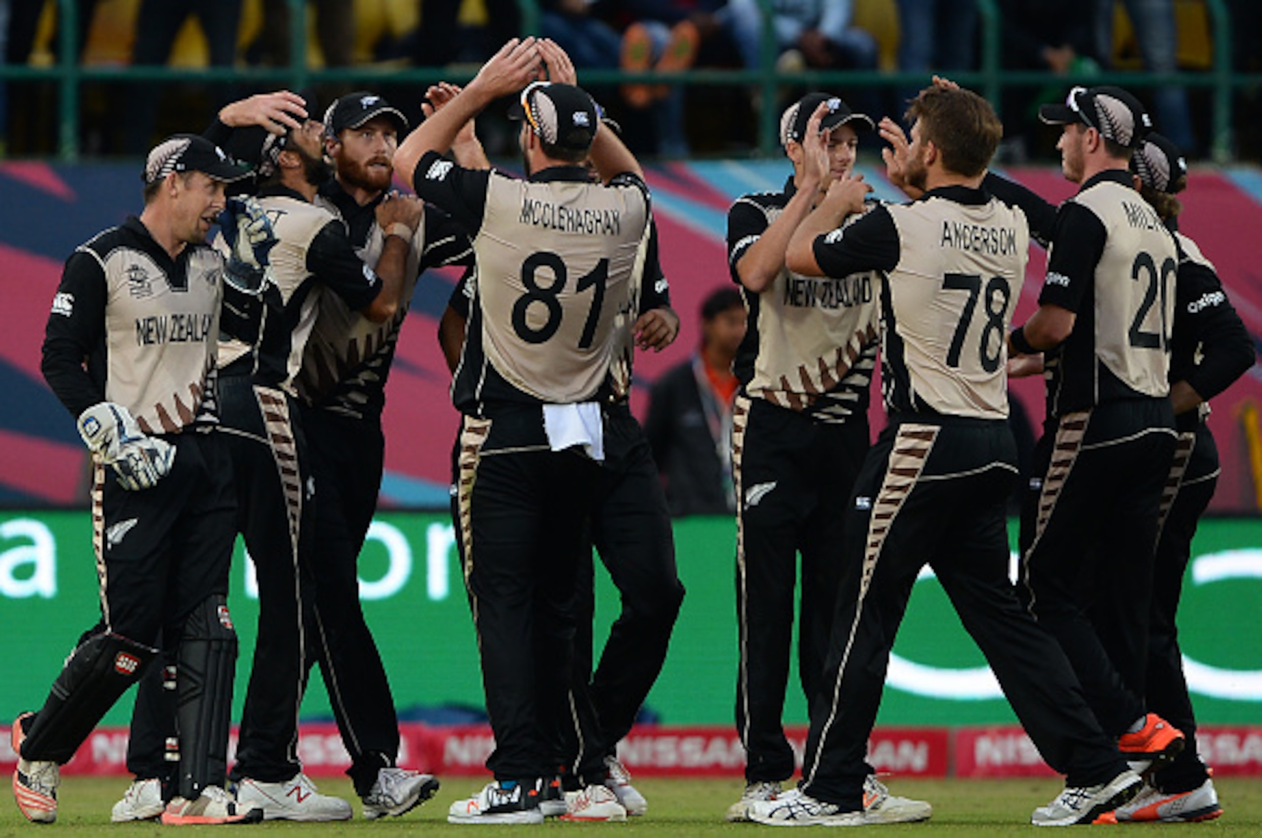 New Zealand's cricketers celebrate after victory in the World T20 cricket tournament match between Australia and New Zealand at The Himachal Pradesh Cricket Association Stadium (HPCA) in Dharamsala on March 18, 2016.
 / AFP / SAJJAD HUSSAIN        (Photo 