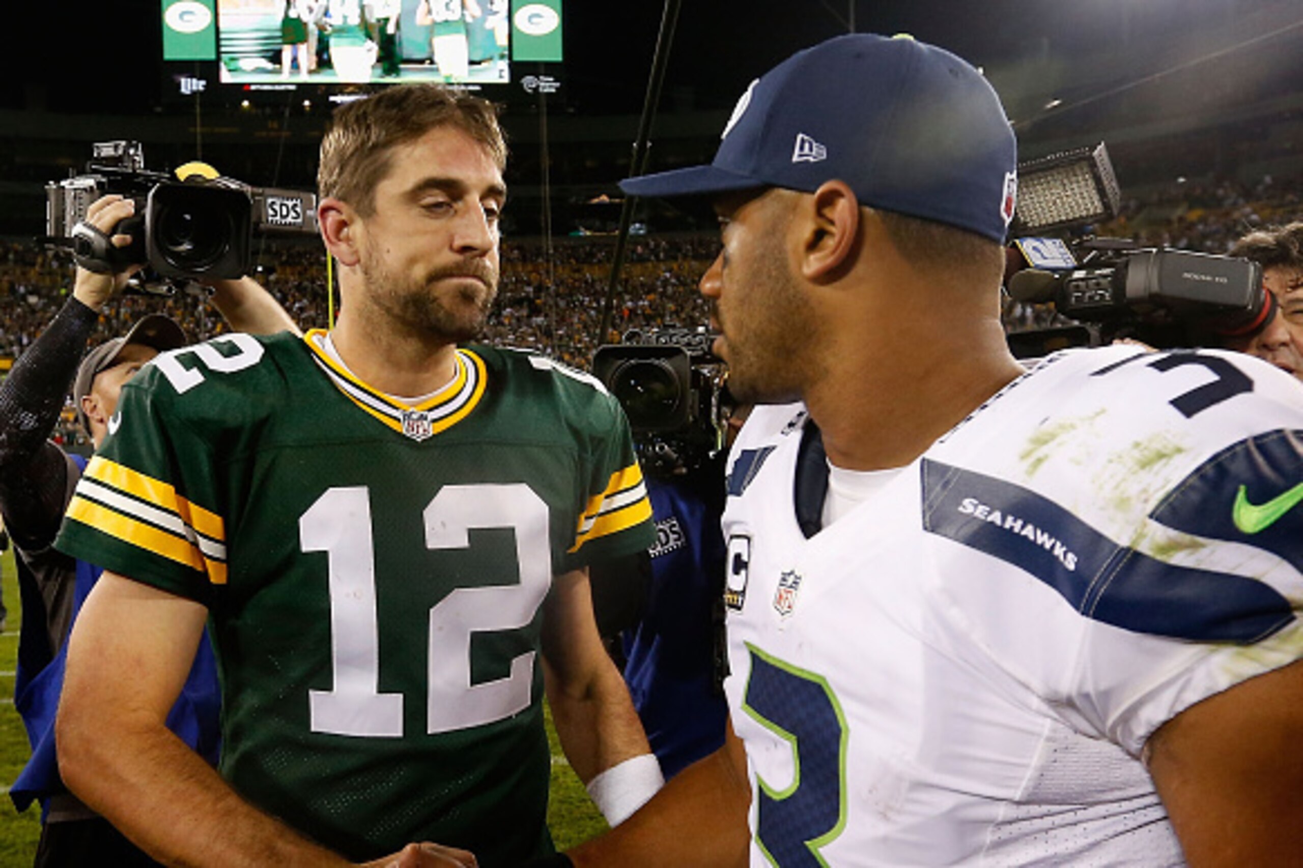 GREEN BAY, WI - SEPTEMBER 20:  Quarterbacks Aaron Rodgers #12 of the Green Bay Packers and Russell Wilson #3 of the Seattle Seahawks shake hands following the NFL game at Lambeau Field on September 20, 2015 in Green Bay, Wisconsin.  The Packers defeated t
