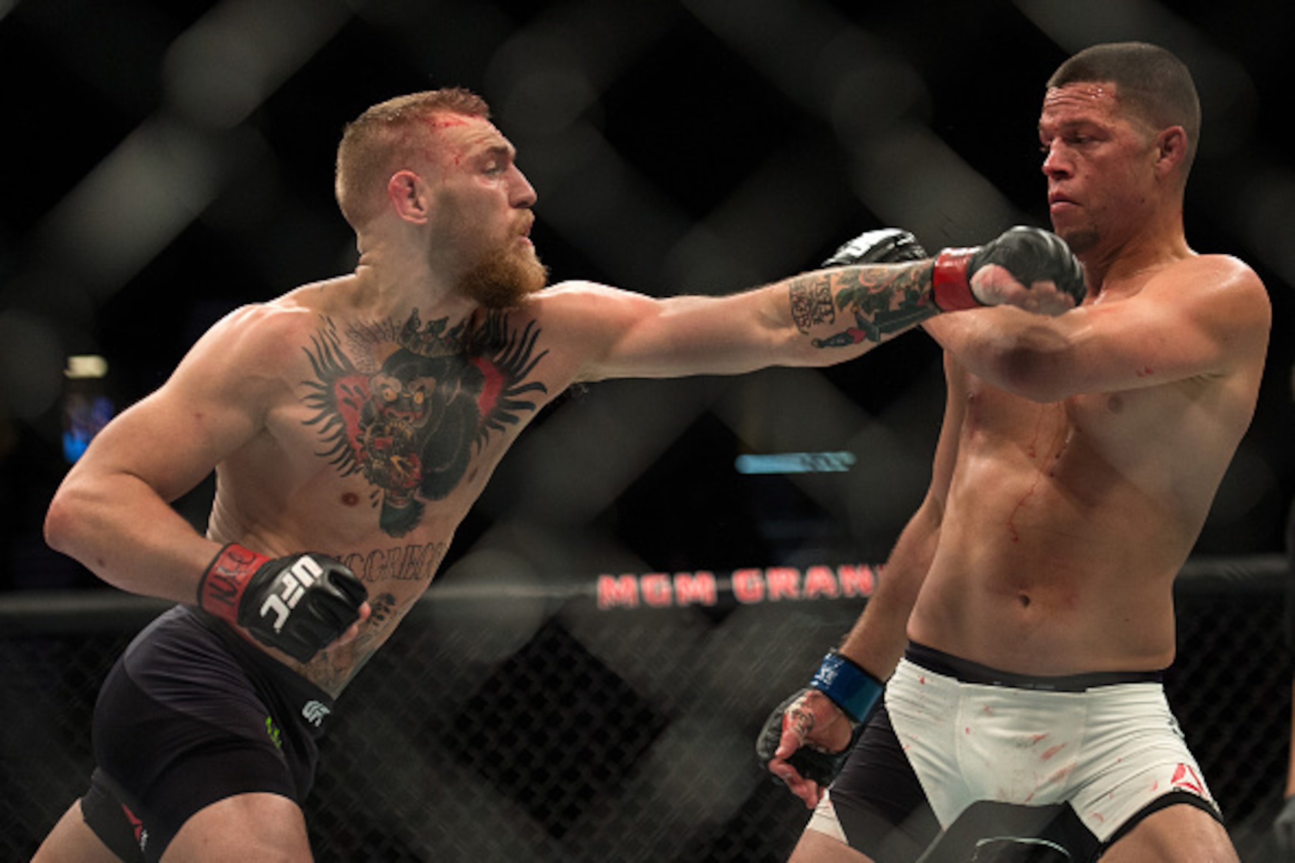 LAS VEGAS, NV - MARCH 5:   (L-R) Conor McGregor punches Nate Diaz in their welterweight bout during the UFC 196 in the MGM Grand Garden Arena on March 5, 2016 in Las Vegas, Nevada. (Photo by Brandon Magnus/Zuffa LLC/Zuffa LLC via Getty Images)