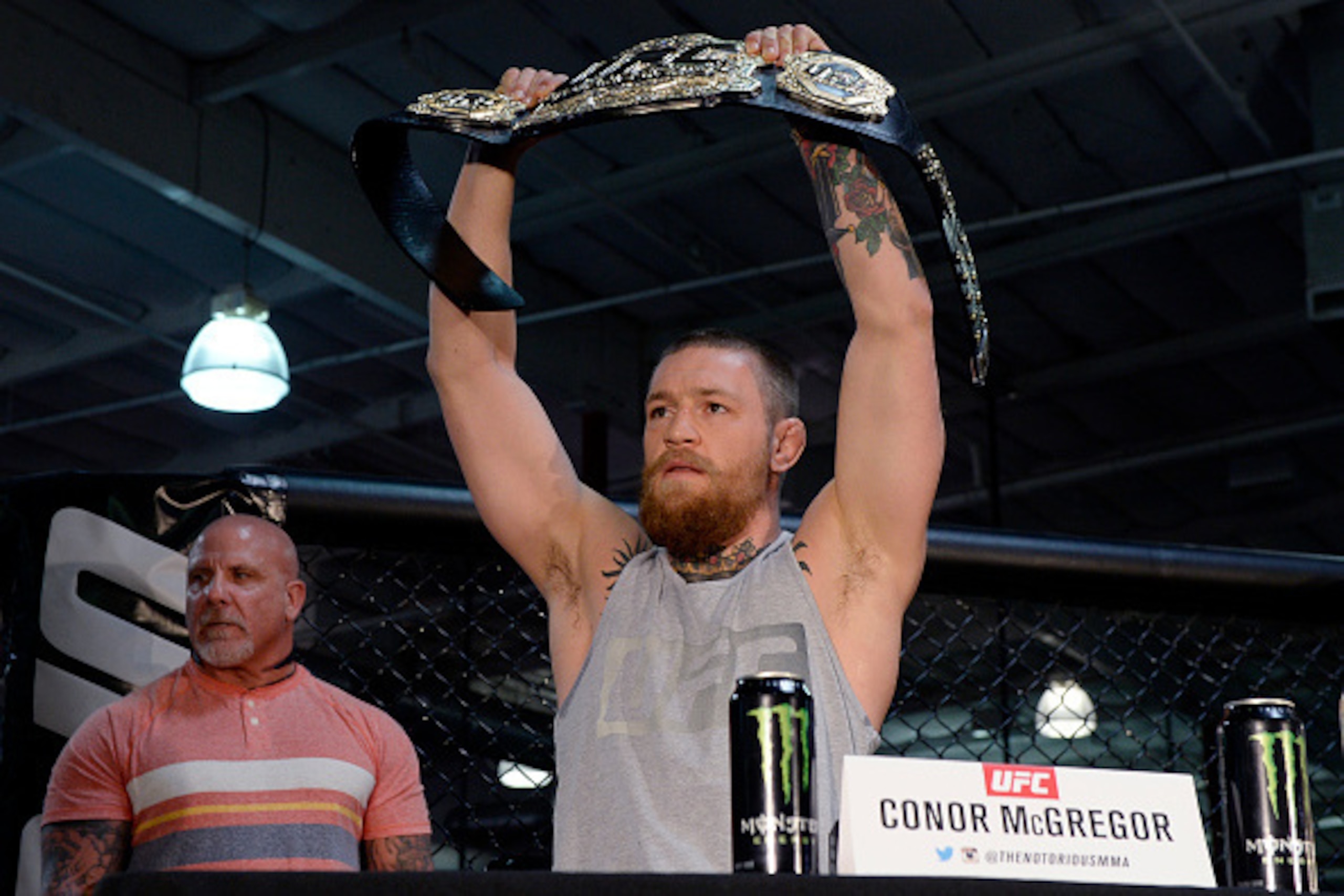 TORRANCE, CA - FEBRUARY 24:  UFC featherweight champion Conor McGregor holds up the championship belt during a news conference with lightweight contender Nate Diaz at UFC Gym February 24, 2016, in Torrance, California. (Photo by Kevork Djansezian/Getty Im
