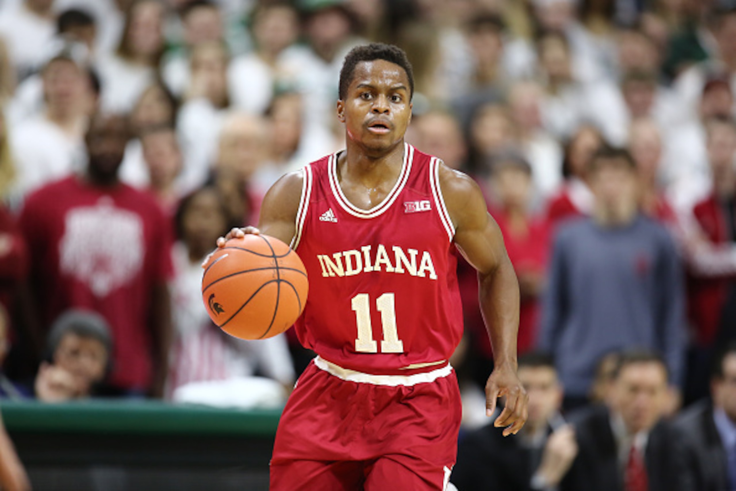 EAST LANSING, MI - FEBRUARY  14:  Yogi Ferrell #11 of the Indiana Hoosiers brings the ball up the court in the first half during the game against the Michigan State Spartans at the Breslin Center on February 14, 2016 in East Lansing, Michigan. (Photo by R