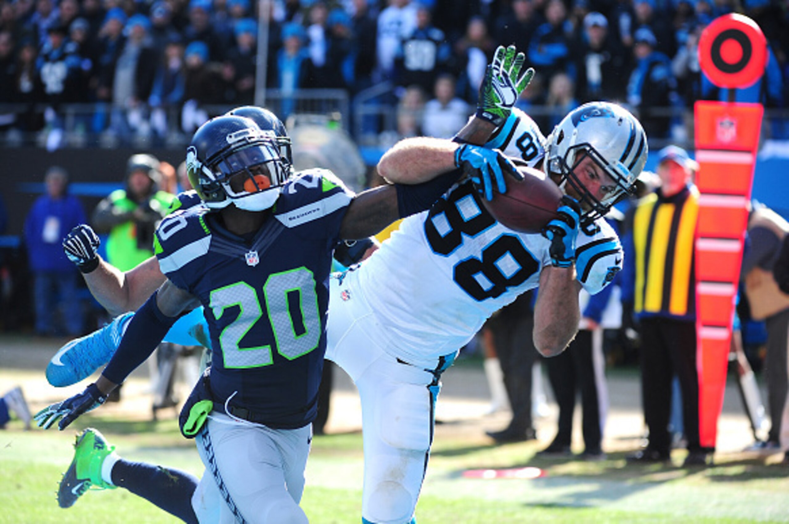 CHARLOTTE, NC - JANUARY 17: Greg Olsen #88 of the Carolina Panthers makes a catch for a touchdown against Jeremy Lane #20 of the Seattle Seahawks during the NFC Divisional Playoff Game at Bank Of America Stadium on January 17, 2016 in Charlotte, North Car