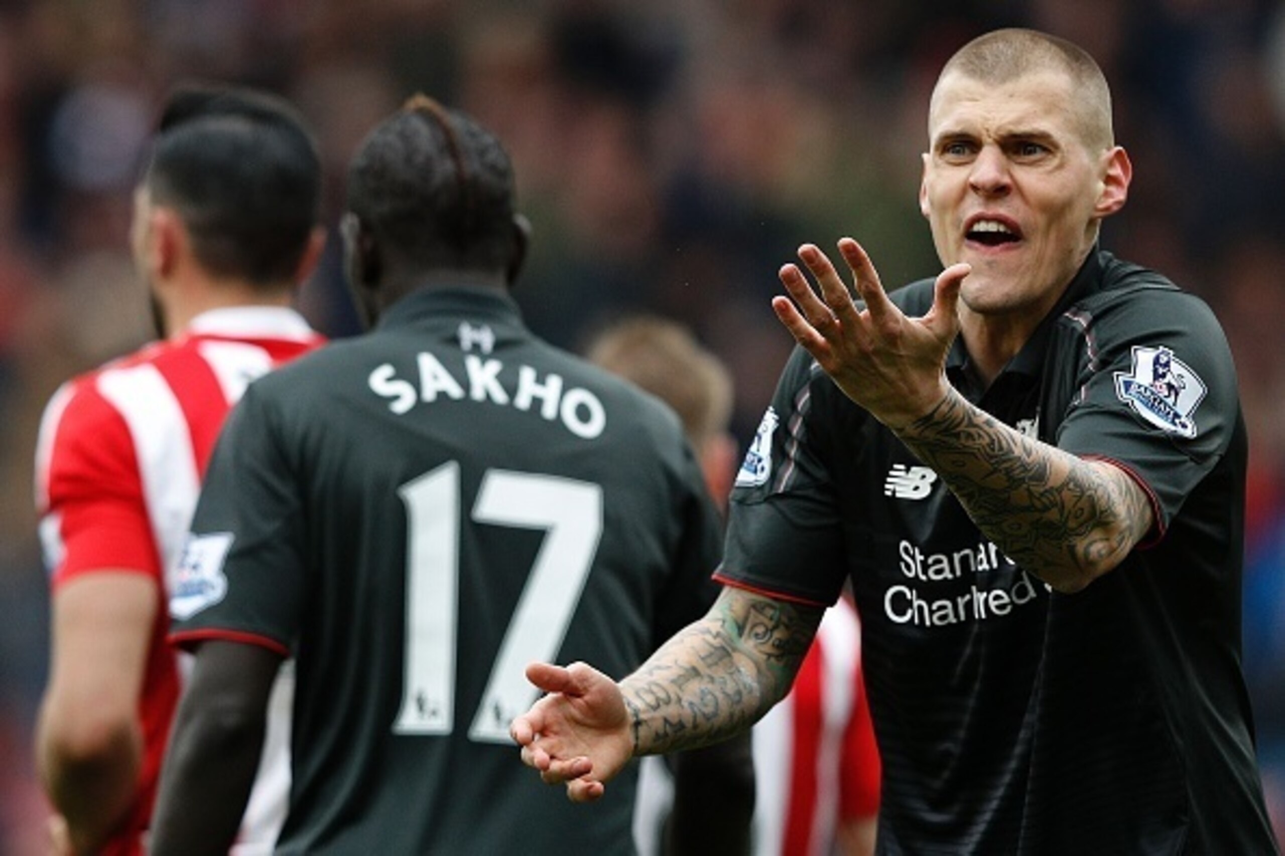 Liverpool's Slovakian defender Martin Skrtel (R) reacts after Referee Roger East (not pictured) showed him a yellow card following his challenge on Southampton's Italian striker Graziano Pelle (not pictured), and awarding Southampton a penalty during the 