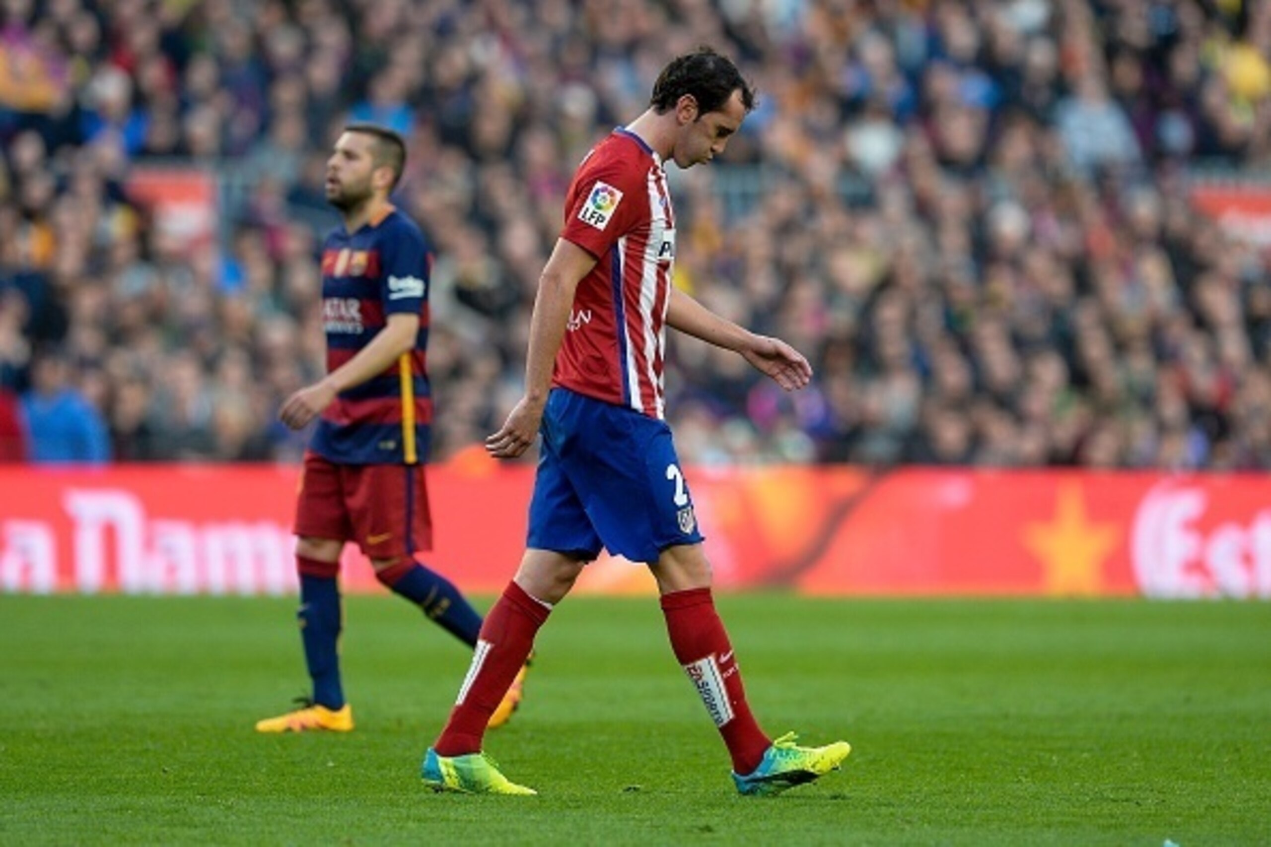 Atletico Madrid's Uruguayan defender Diego Godin leaves the pitch after being sent off by referee during the Spanish league football match FC Barcelona vs Club Atletico de Madrid at the Camp Nou stadium in Barcelona on January 30, 2016. Barcelona won 2-1.