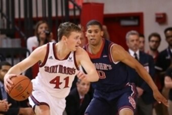 Dec 19, 2014; Jamaica, NY, USA;  St. Mary's Gaels guard Emmett Naar (41) drives past St. John's Red Storm guard Jamal Branch (0) during the second half at Carnesecca Arena. St. John's Red Storm won 53-47. Mandatory Credit: Anthony Gruppuso-USA TODAY Sport