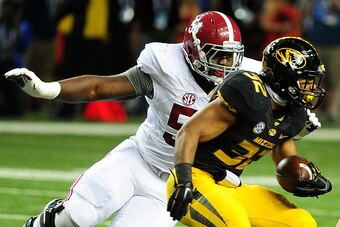 ATLANTA, GA - DECEMBER 06:  Dalvin Tomlinson #54 of the Alabama Crimson Tide tackles Russell Hansbrough #32 of the Missouri Tigers in the first half of the SEC Championship game at the Georgia Dome on December 6, 2014 in Atlanta, Georgia.  (Photo by Scott