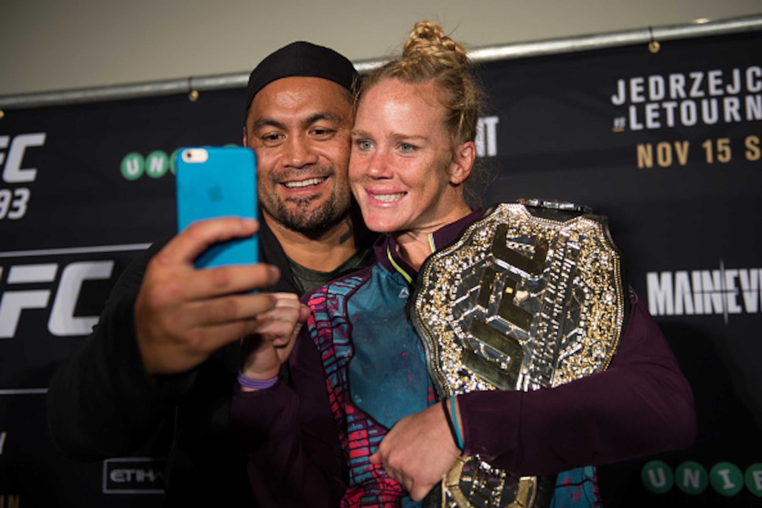 MELBOURNE, AUSTRALIA - NOVEMBER 15:  New UFC women's bantamweight champion Holly Holm of the United States and Mark Hunt of New Zealand take a photo during the UFC 193 post fight press conference at Etihad Stadium on November 15, 2015 in Melbourne, Austra