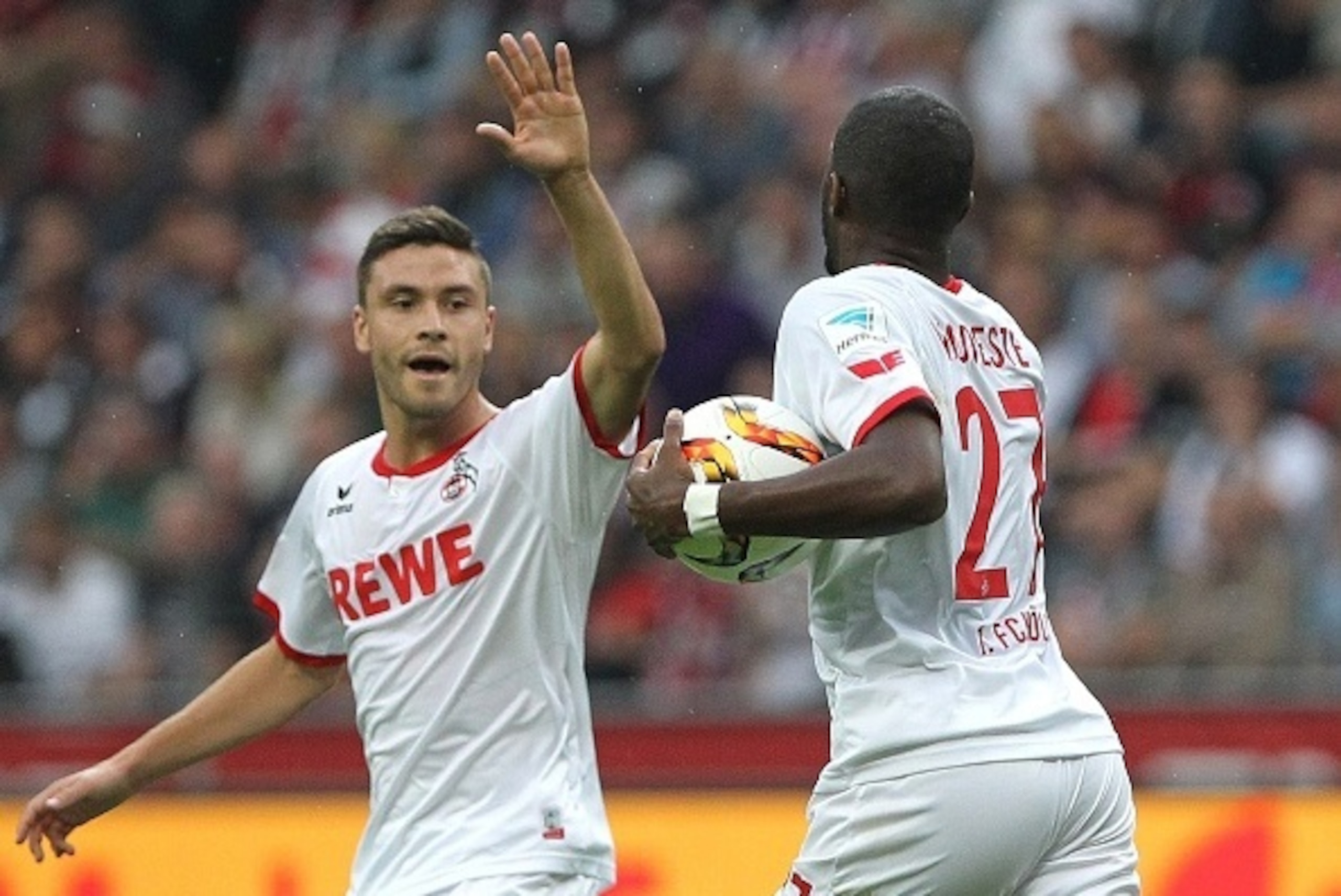 Cologne's French forward Anthony Modeste (R) holds the ball after scoring his team's first goal next to Cologne's defender Jonas Hector during the German first division Bundesliga football match Eintracht Frankfurt vs 1FC Cologne in Frankfurt am Main, wes