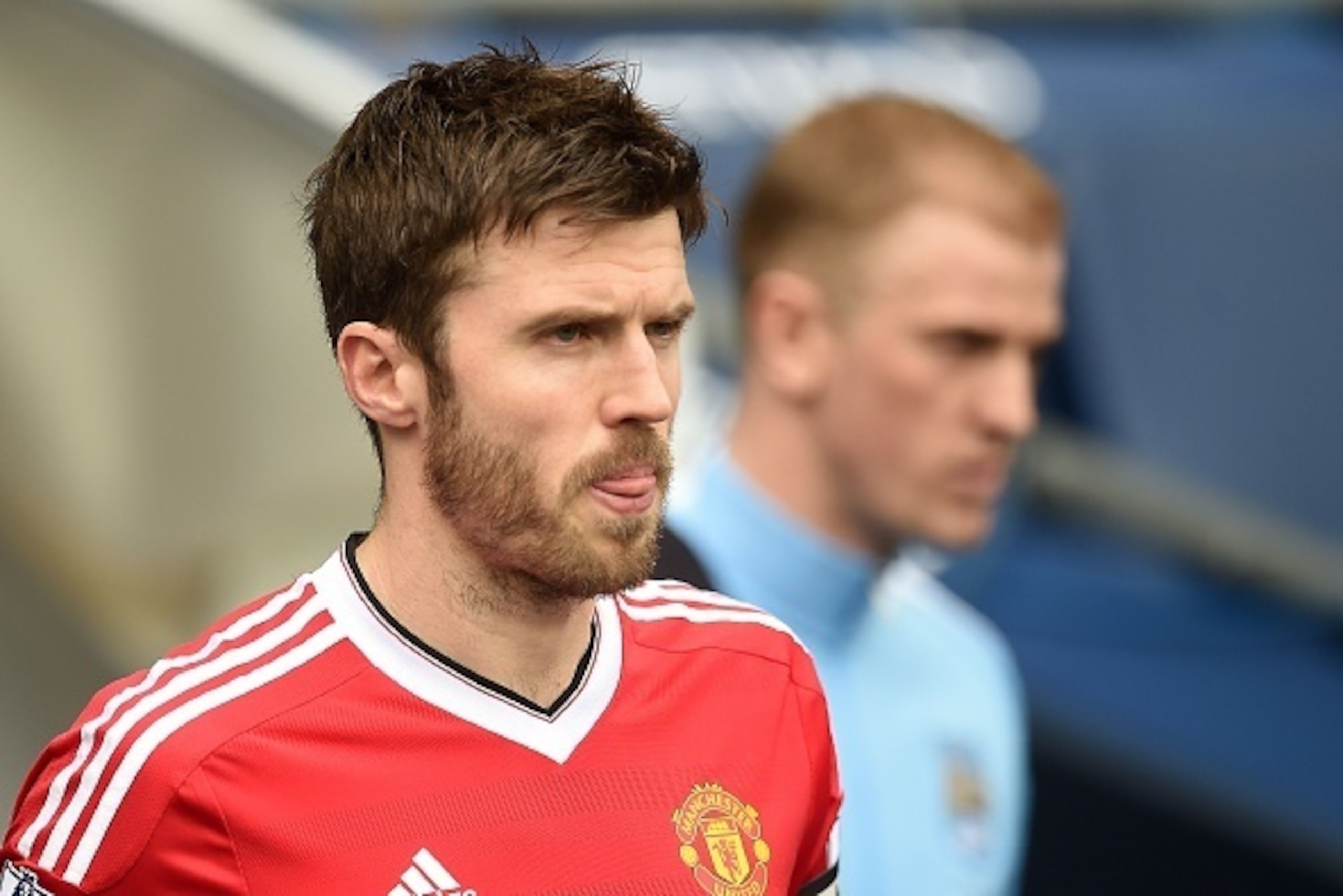 Manchester United's English midfielder Michael Carrick (L) leads his team out onto the pitch during the English Premier League football match between Manchester City and Manchester United at the Etihad Stadium in Manchester, north west England, on March 2