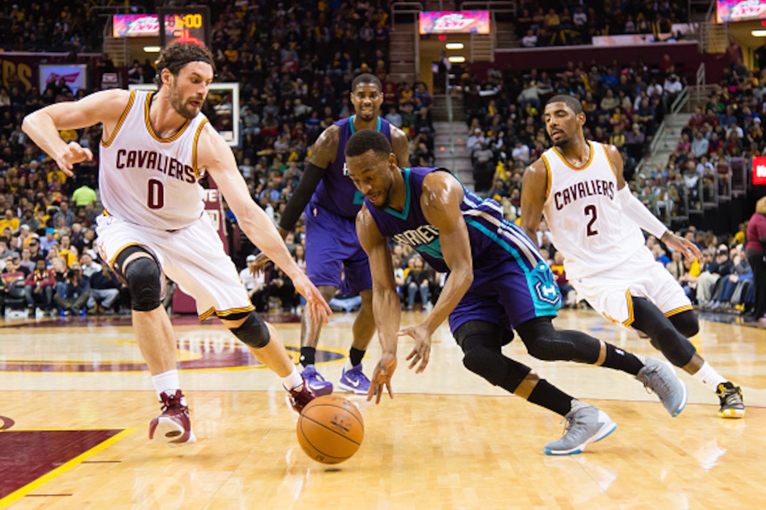CLEVELAND, OH - FEBRUARY 24: Kemba Walker #15 of the Charlotte Hornets drives past Kevin Love #0 and Kyrie Irving #2 of the Cleveland Cavaliers during the second half at Quicken Loans Arena on February 24, 2016 in Cleveland, Ohio. The Cavaliers defeated t CLEVELAND, OH - FEBRUARY 24: Kemba Walker #15 of the Charlotte Hornets drives past Kevin Love #0 and Kyrie Irving #2 of the Cleveland Cavaliers during the second half at Quicken Loans Arena on February 24, 2016 in Cleveland, Ohio. The Cavaliers defeated t