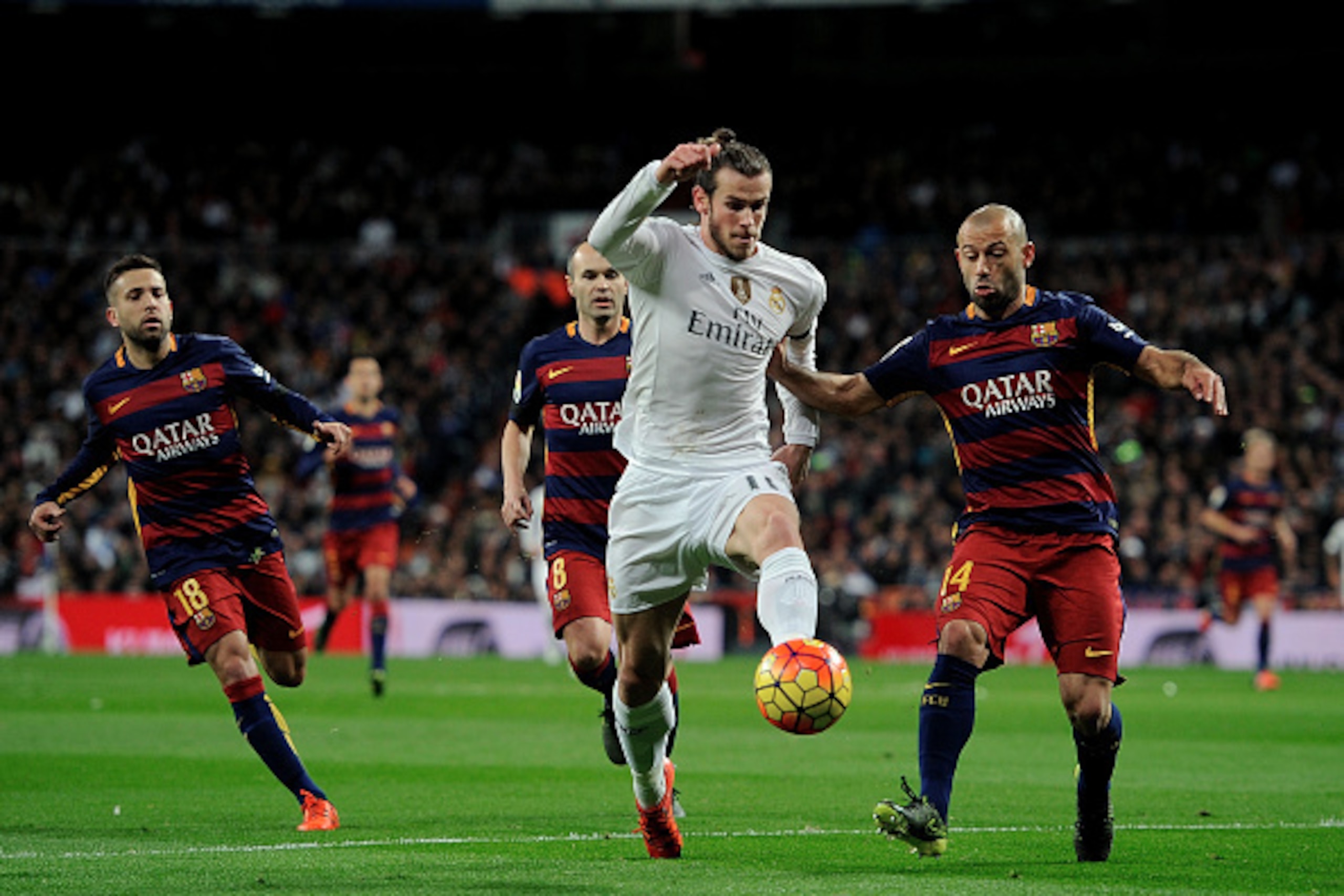 MADRID, SPAIN - NOVEMBER 21:  Gareth Bale of Real Madrid is tackled by Javier Mascherano of FC Barcelona during the La Liga match between Real Madrid and Barcelona at Estadio Santiago Bernabeu on November 21, 2015 in Madrid, Spain.  (Photo by Denis Doyle/