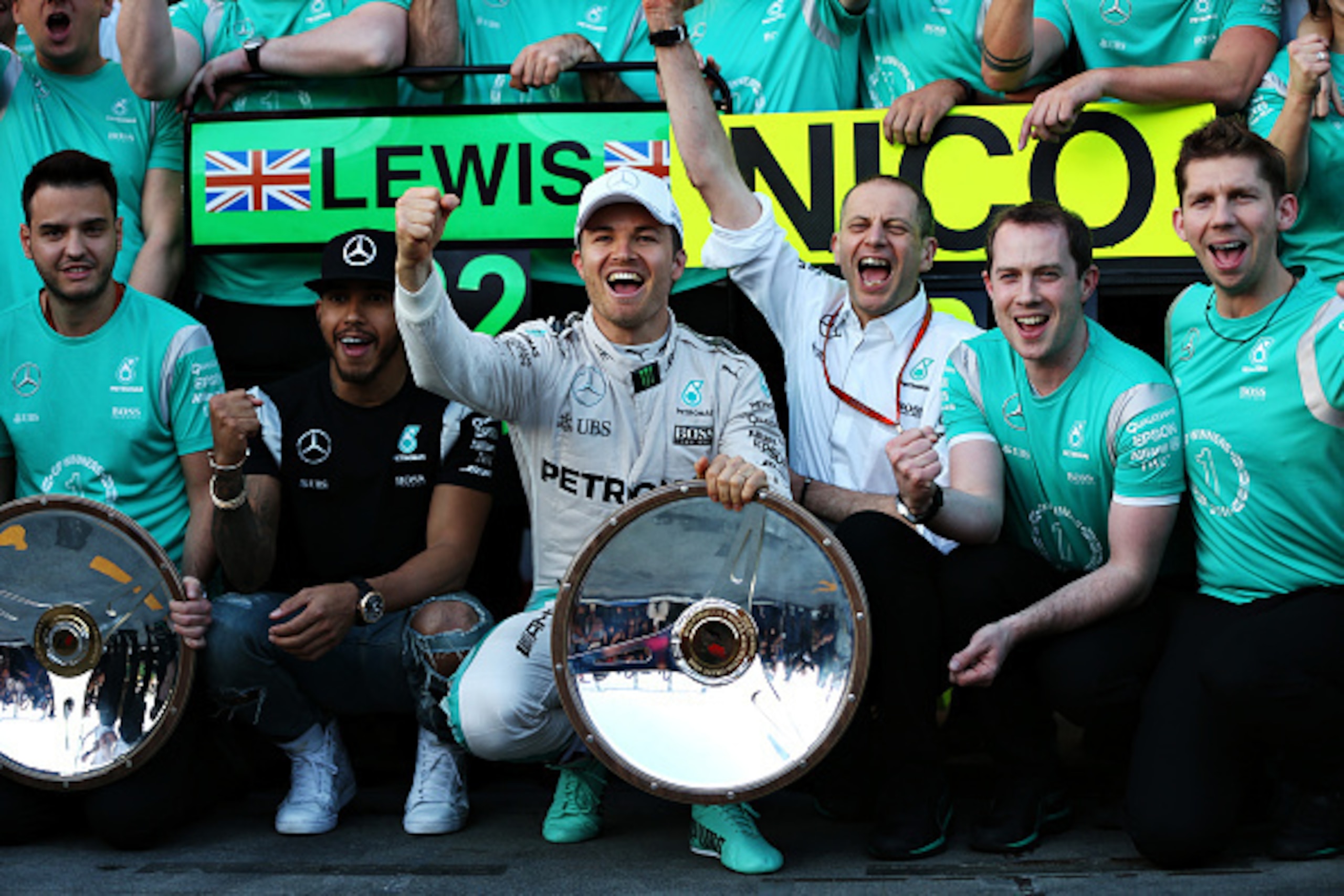 MELBOURNE, AUSTRALIA - MARCH 20: Nico Rosberg of Germany and Mercedes GP celebrates with Lewis Hamilton of Great Britain and Mercedes GP and his team during the Australian Formula One Grand Prix at Albert Park on March 20, 2016 in Melbourne, Australia.  (