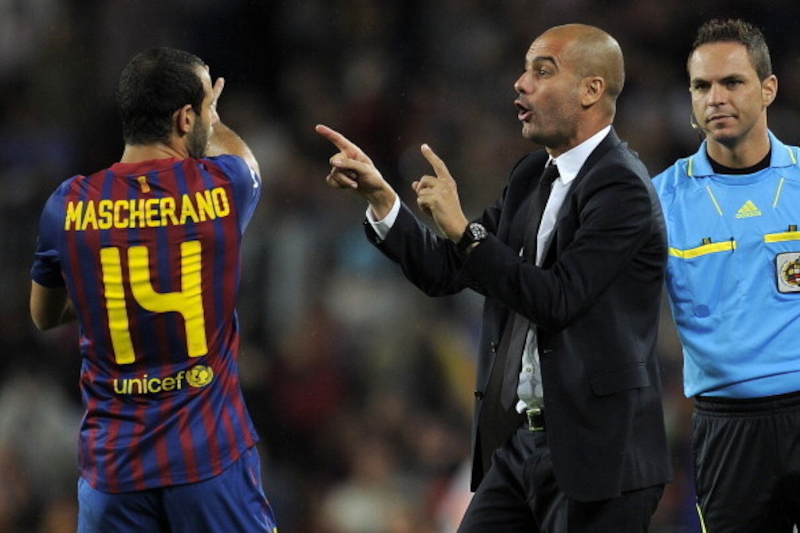 Barcelona's coach Josep Guardiola gives orders to Barcelona's Argentinian midfielder Javier Mascherano (L) during their Spanish League football match between FC Barcelona and Atletico de Madrid on September 24, 2011 at Camp Nou stadium in Barcelona. AFP P