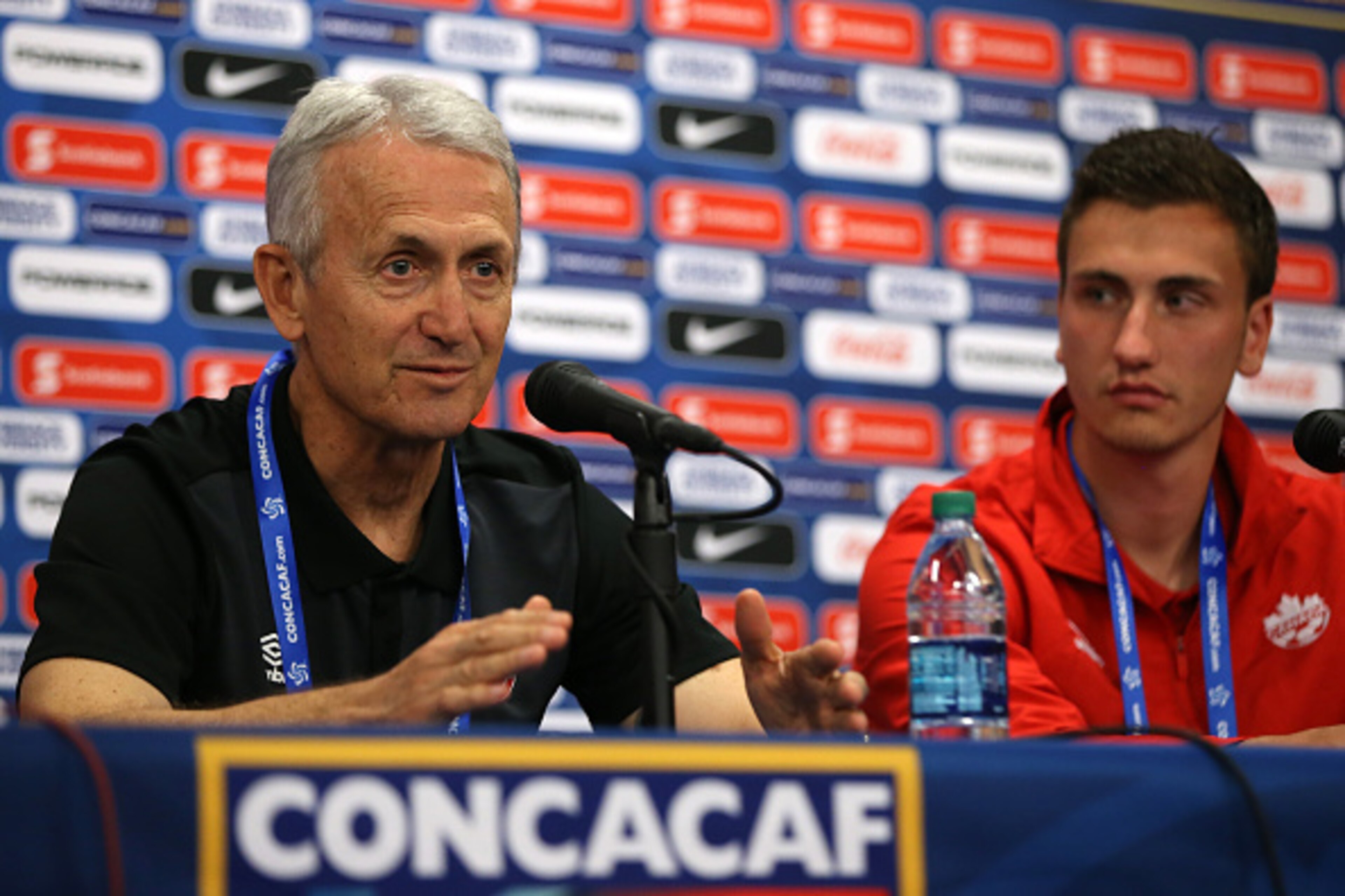 COMMERCE CITY, CO - OCTOBER 05: Head coach Benito Floro (L) of the Canadian U-23 men's soccer team addresses the media along with player Luca Gasparotto (R) during a press conference ahead of the 2015 CONCACAF Olympic Qualifying group play matches at Dic COMMERCE CITY, CO - OCTOBER 05: Head coach Benito Floro (L) of the Canadian U-23 men's soccer team addresses the media along with player Luca Gasparotto (R) during a press conference ahead of the 2015 CONCACAF Olympic Qualifying group play matches at Dic