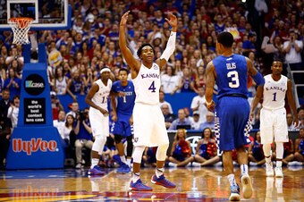 LAWRENCE, KS - JANUARY 30:  Devonte' Graham #4 of the Kansas Jayhawks energizes the crowd during the 1st half of the game against the Kentucky Wildcats at Allen Fieldhouse on January 30, 2016 in Lawrence, Kansas.  (Photo by Jamie Squire/Getty Images)