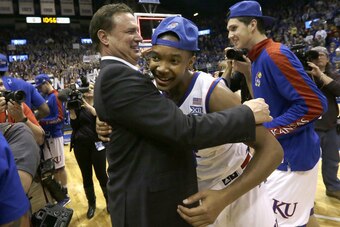 Bill Self and Devonte' Graham celebrate Kansas' win in the 2015 Big 12 conference championship.