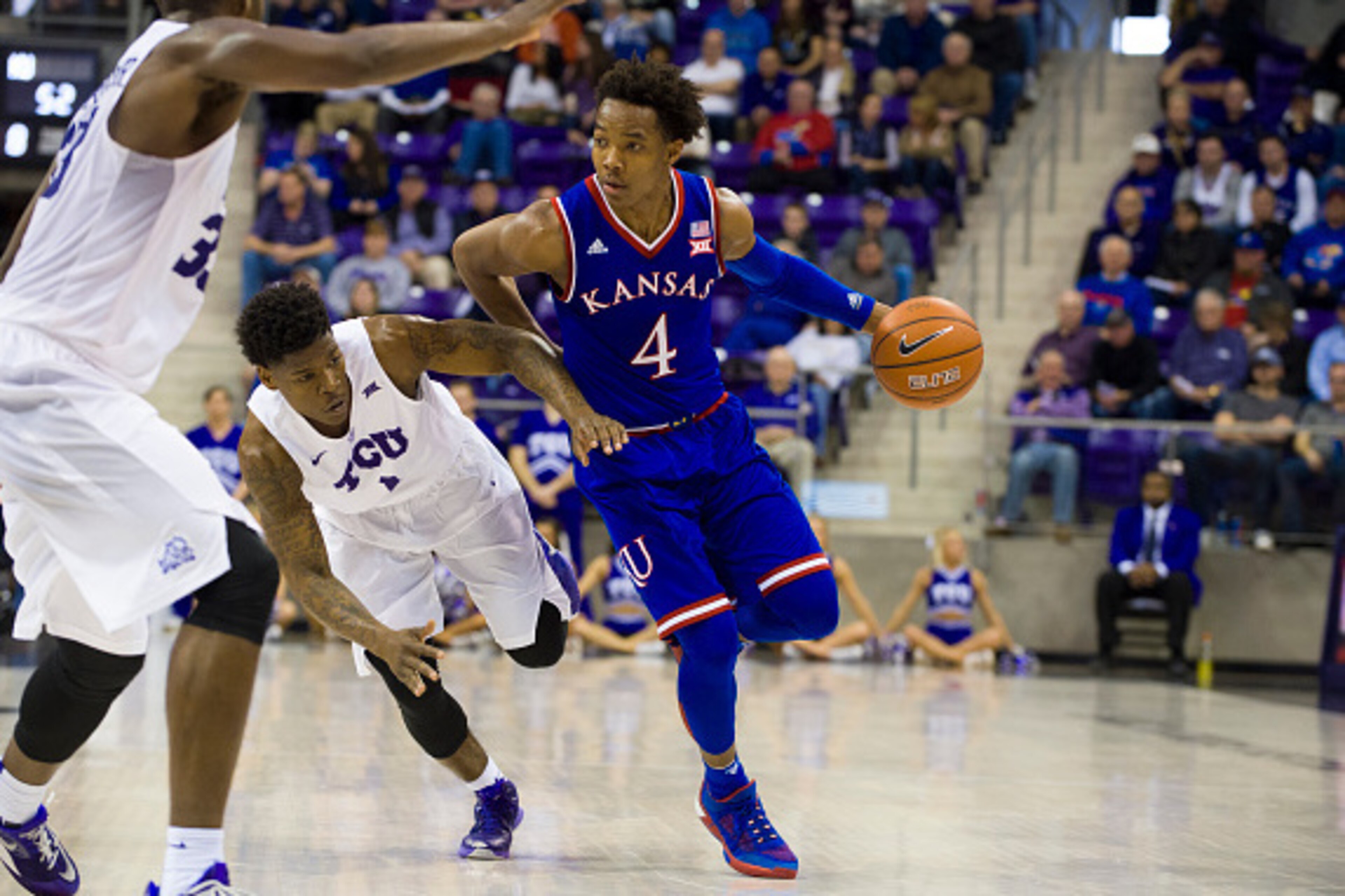 FORT WORTH, TX - FEBRUARY 6: Devonte' Graham #4 of the Kansas Jayhawks drives to the basket against Chauncey Collins #1 of the TCU Horned Frogs on February 6, 2016 at the Ed and Rae Schollmaier Arena in Fort Worth, Texas. (Photo by Cooper Neill/Getty Ima FORT WORTH, TX - FEBRUARY 6: Devonte' Graham #4 of the Kansas Jayhawks drives to the basket against Chauncey Collins #1 of the TCU Horned Frogs on February 6, 2016 at the Ed and Rae Schollmaier Arena in Fort Worth, Texas. (Photo by Cooper Neill/Getty Ima