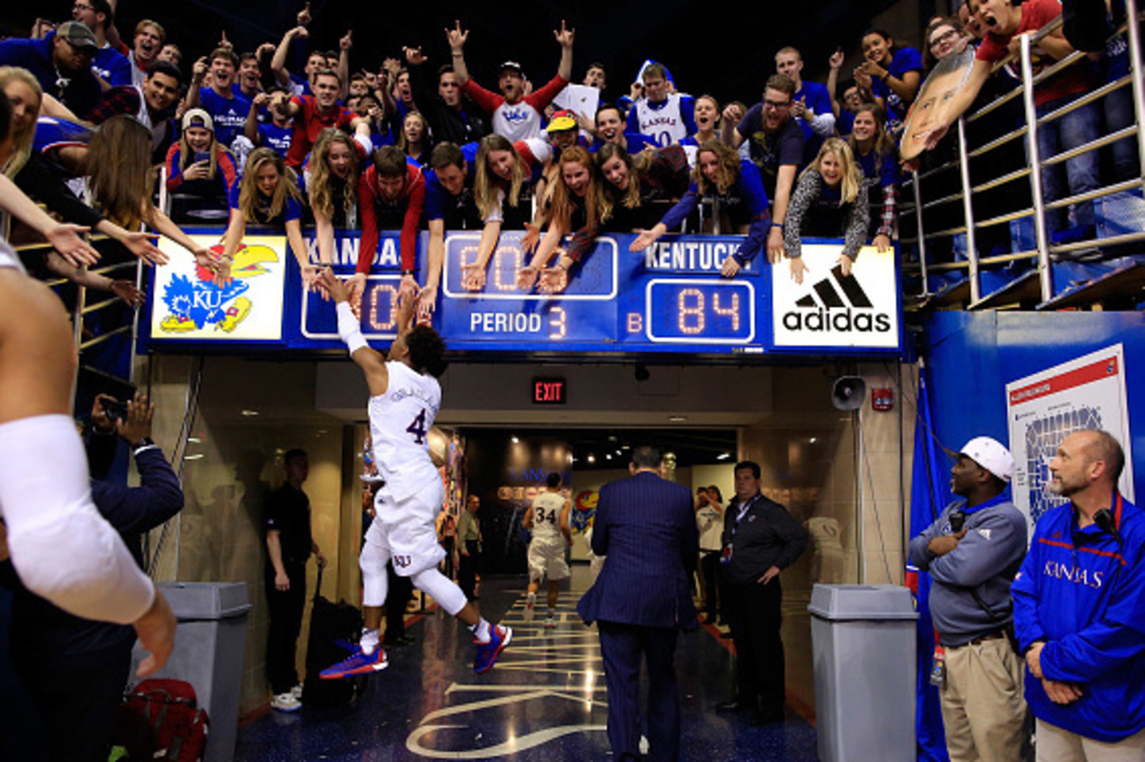 LAWRENCE, KS - JANUARY 30: Devonte' Graham #4 of the Kansas Jayhawks leaps to high-five fans as he runs off the floor following the Jayhawks 90-84 victory over the Kentucky Wildcats to win the game at Allen Fieldhouse on January 30, 2016 in Lawrence, Kan LAWRENCE, KS - JANUARY 30: Devonte' Graham #4 of the Kansas Jayhawks leaps to high-five fans as he runs off the floor following the Jayhawks 90-84 victory over the Kentucky Wildcats to win the game at Allen Fieldhouse on January 30, 2016 in Lawrence, Kan