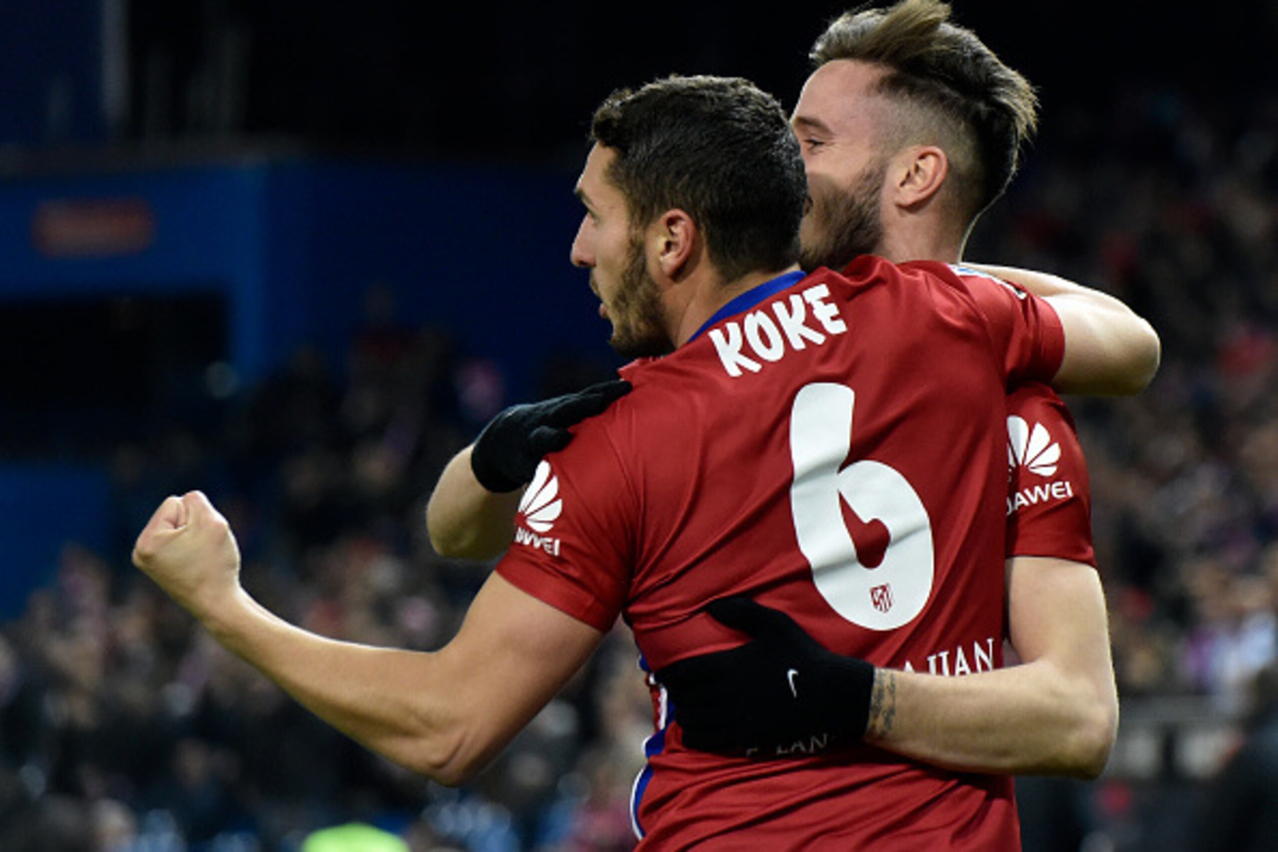 Atletico Madrid's midfielder Saul Niguez is congratulated by Atletico Madrid's midfielder Koke (L) during the Spanish league football match Club Atletico de Madrid vs Real Sociedad de Futbol at the Vicente Calderon stadium in Madrid on March 1, 2016. / AF