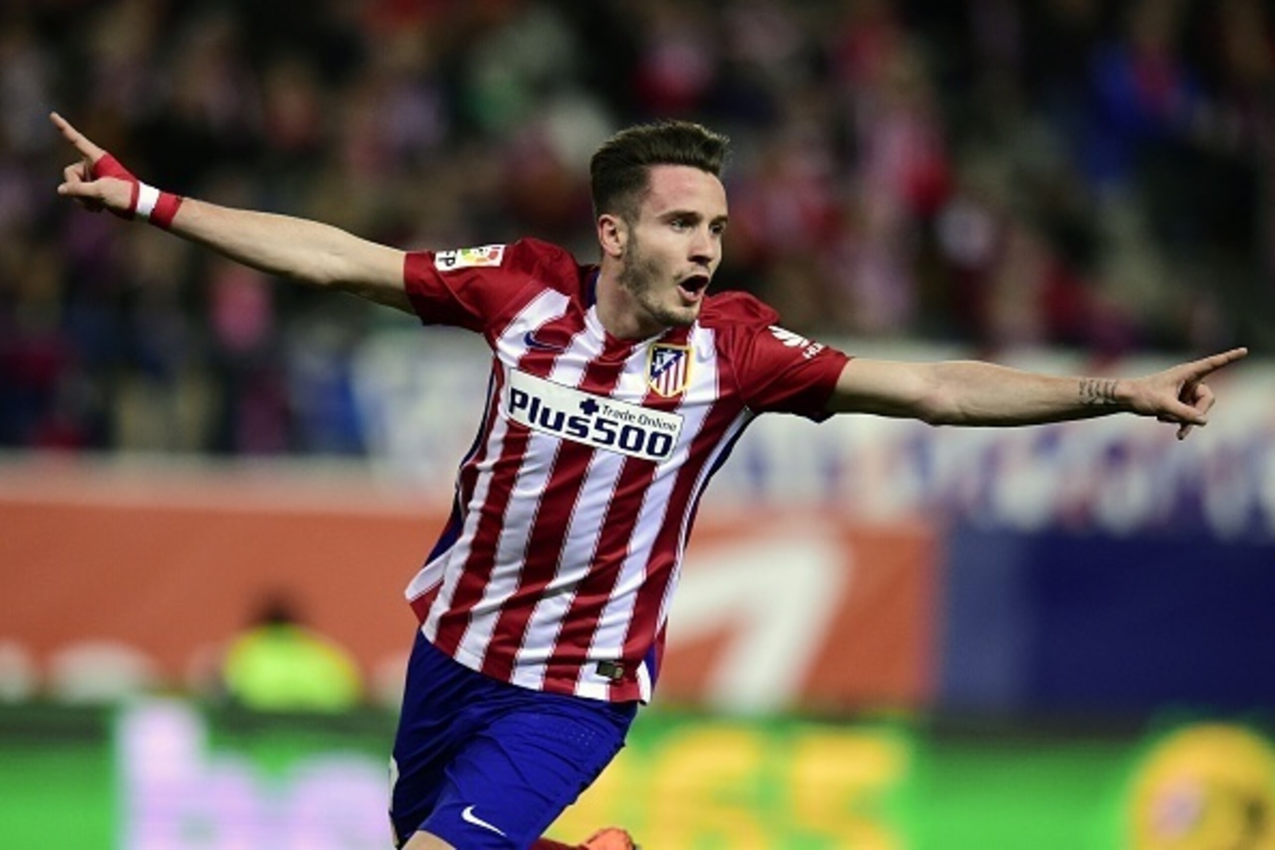 Atletico Madrid's midfielder Saul Niguez celebrates after scoring during the Spanish league football match Club Atletico de Madrid vs RC Deportivo La Coruna at the Vicente Calderon stadium in Madrid on March 12, 2016. / AFP / JAVIER SORIANO        (Photo 