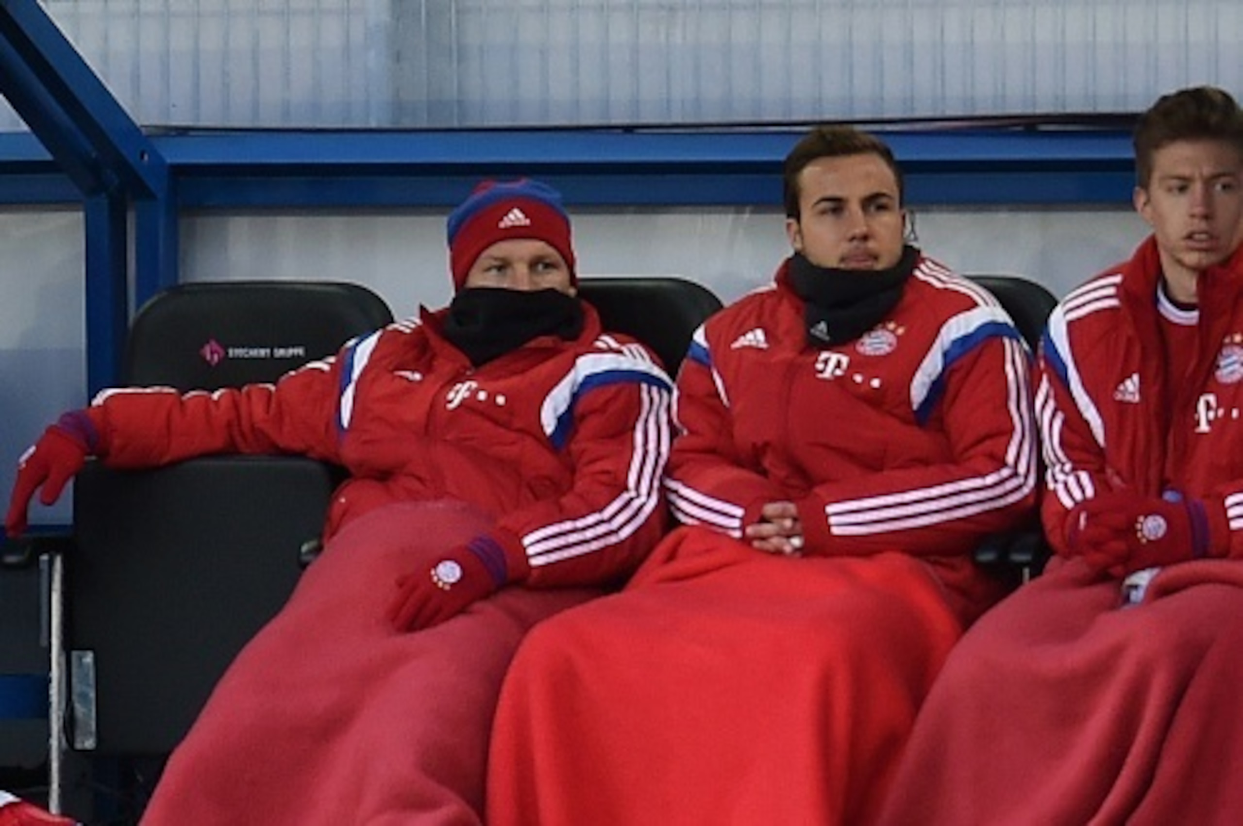 Bayern Munich's midfielder Mario Goetze (2nd R) and Bayern Munich's midfielder Bastian Schweinsteiger (3rd R) sit on the bench during the German first division Bundesliga football match SC Paderborn 07 vs FC Bayern Munich in Padeborn, western Germany on F