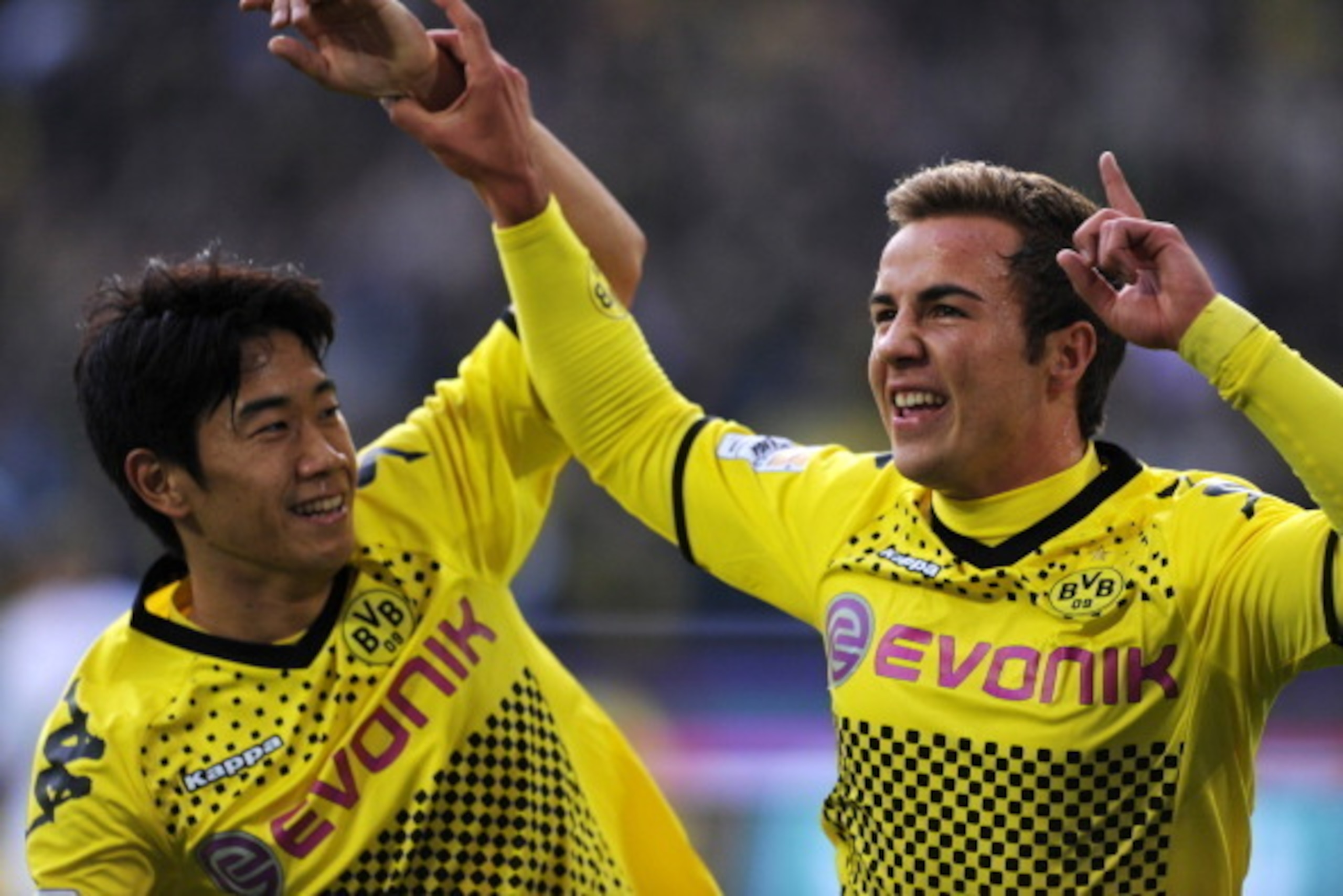 Dortmund's midfielder Mario Goetze (R) celebrates scoring with Dortmund's Japanese forward Shinji Kagawa during the German first division Bundesliga football match Borussia Dortmund vs VfL Wolfsburg in the western German city of Dortmund on November 5, 20