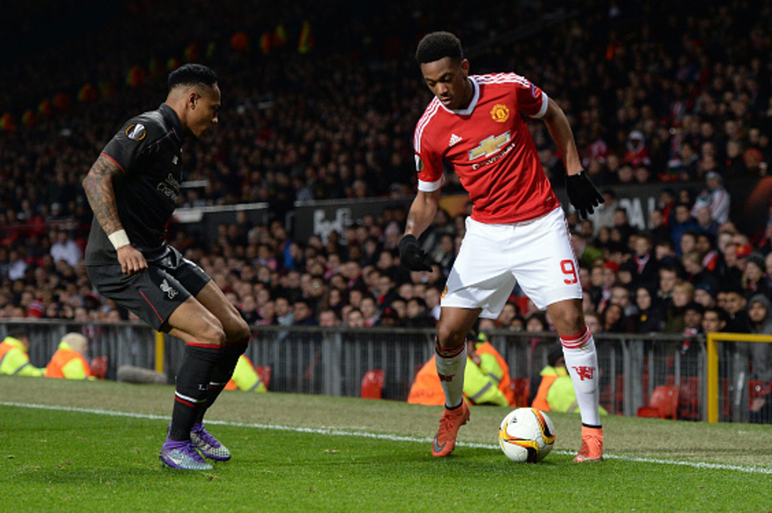 Manchester United's French striker Anthony Martial (R) vies with Liverpool's English defender Nathaniel Clyne during the UEFA Europa League round of 16, second leg football match between Manchester United and Liverpool at Old Trafford in Manchester, north