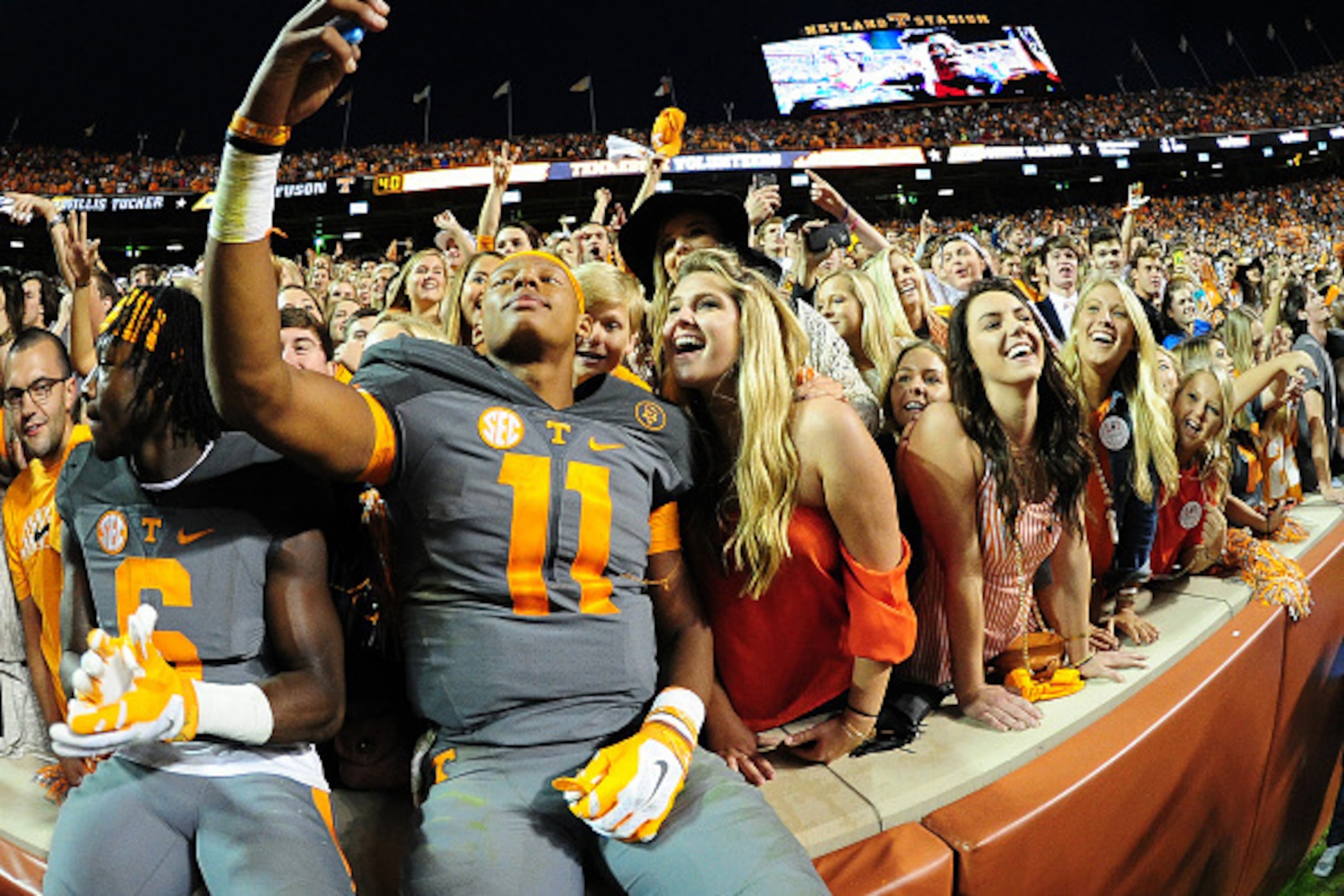 KNOXVILLE, TN - OCTOBER 10: Joshua Dobbs #11 of the Tennessee Volunteers takes a selfie with fans after the game against the Georgia Bulldogs on October 10, 2015 at Neyland Stadium in Knoxville, Tennessee. (Photo by Scott Cunningham/Getty Images)