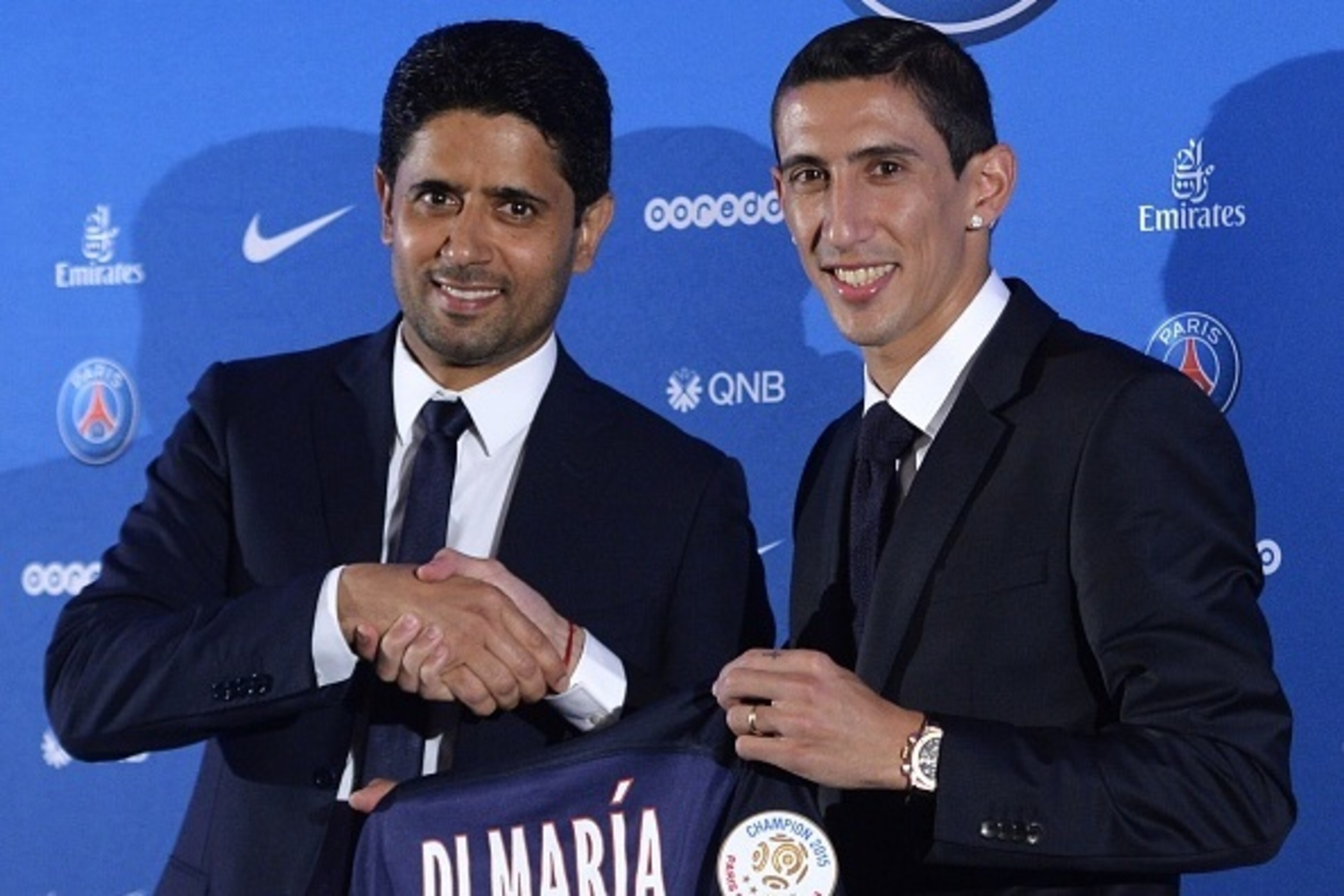 Paris Saint-Germain's (PSG) new Argentinian midfielder Angel Di Maria (R) and Paris Saint-Germain's Qatari president Nasser Al-Khelaifi (L) pose with Di Maria's PSG jersey during an official presentation in Paris on August 6, 2015. Paris Saint-Germain com